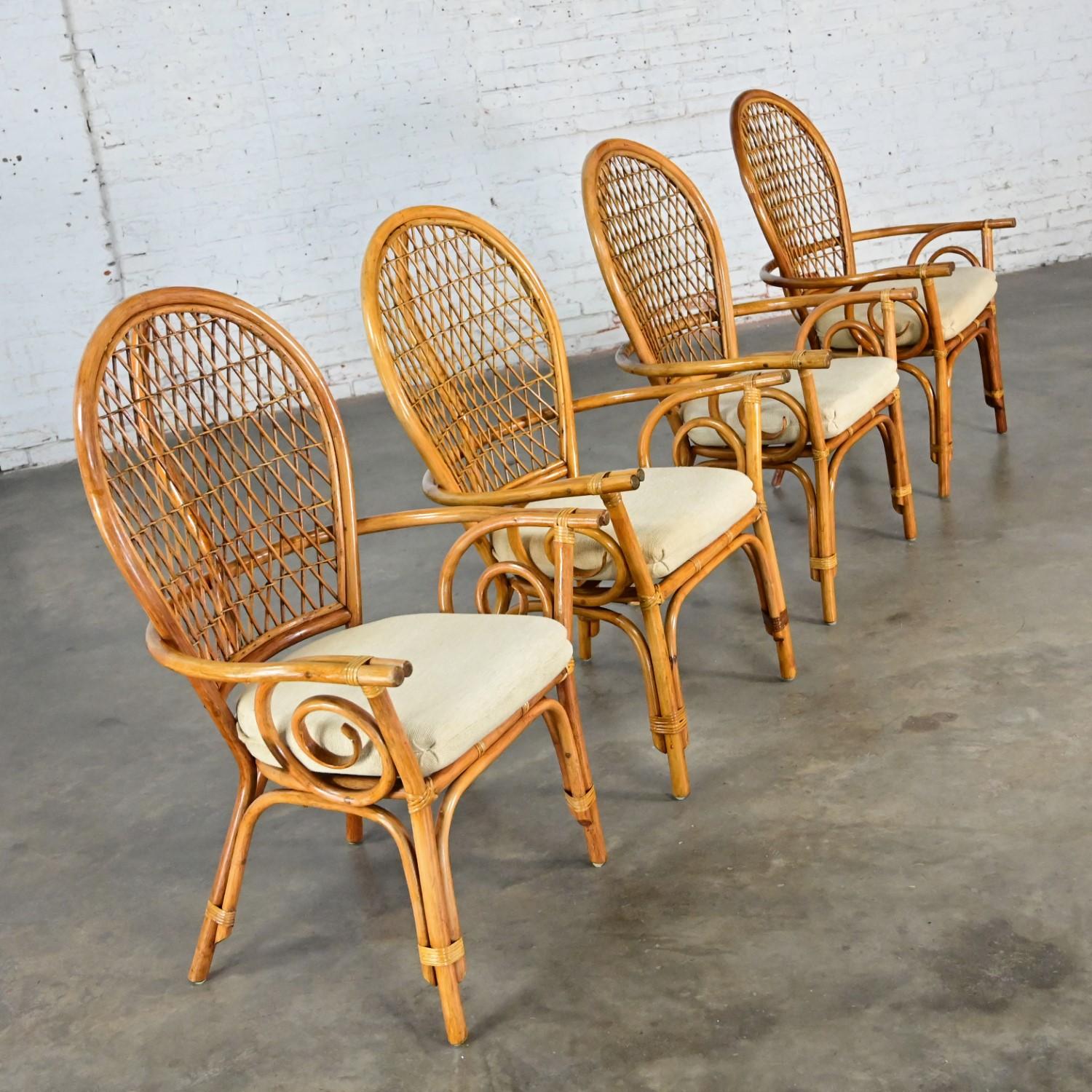 Handsome vintage Coastal Island Style or Hollywood Regency balloon back rattan dining chairs set of 4 with off-white fabric upholstered seat cushions. Beautiful condition, keeping in mind that these are vintage and not new so will have signs of use