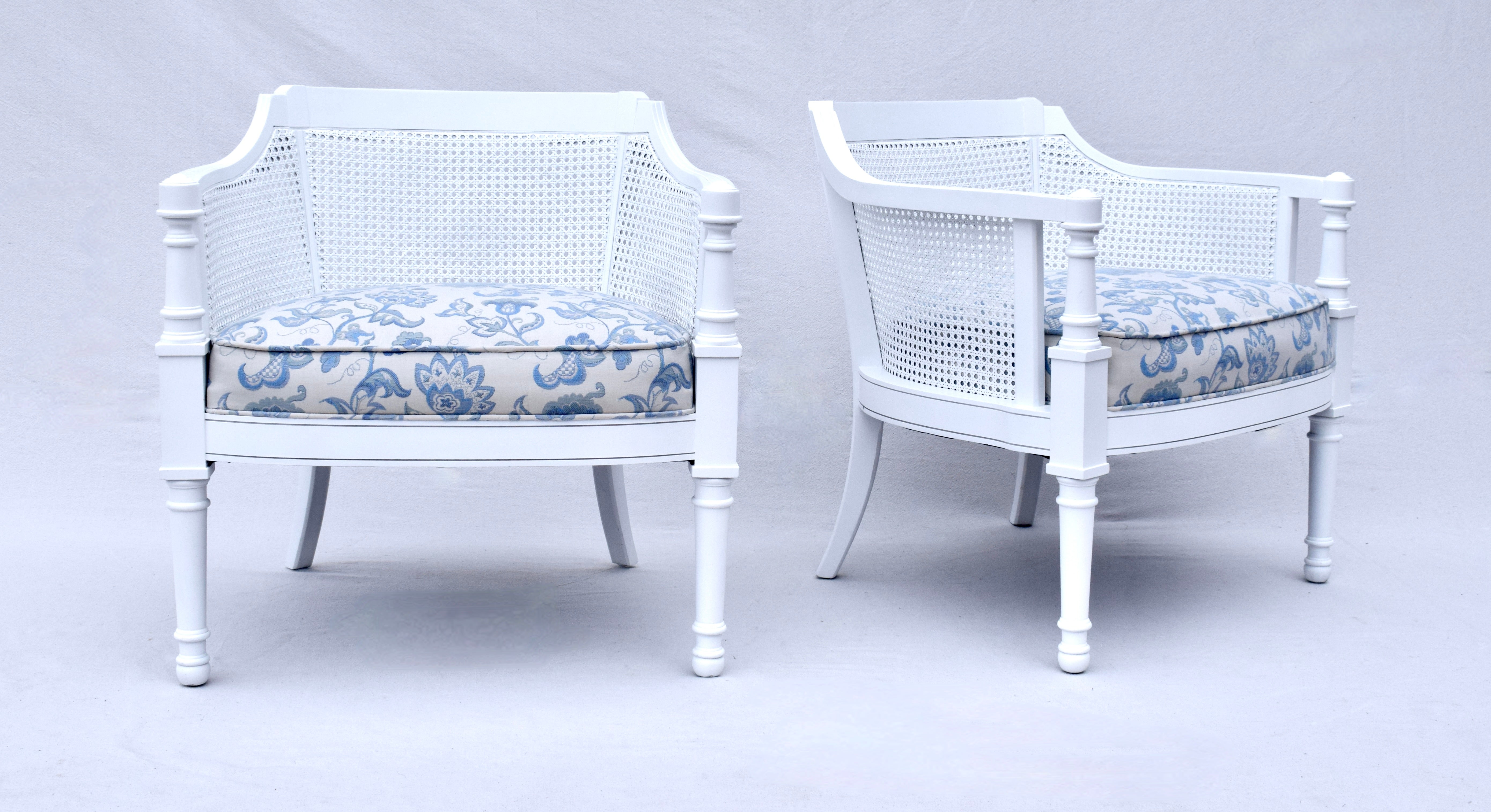 A pair of Mid 20th Century caned barrel chairs professionally painted with vintage Cornflower blue & white embroidered Brunschwig & Fils upholstery. Fully restored one of a kind set in excellent condition. Seats: 18