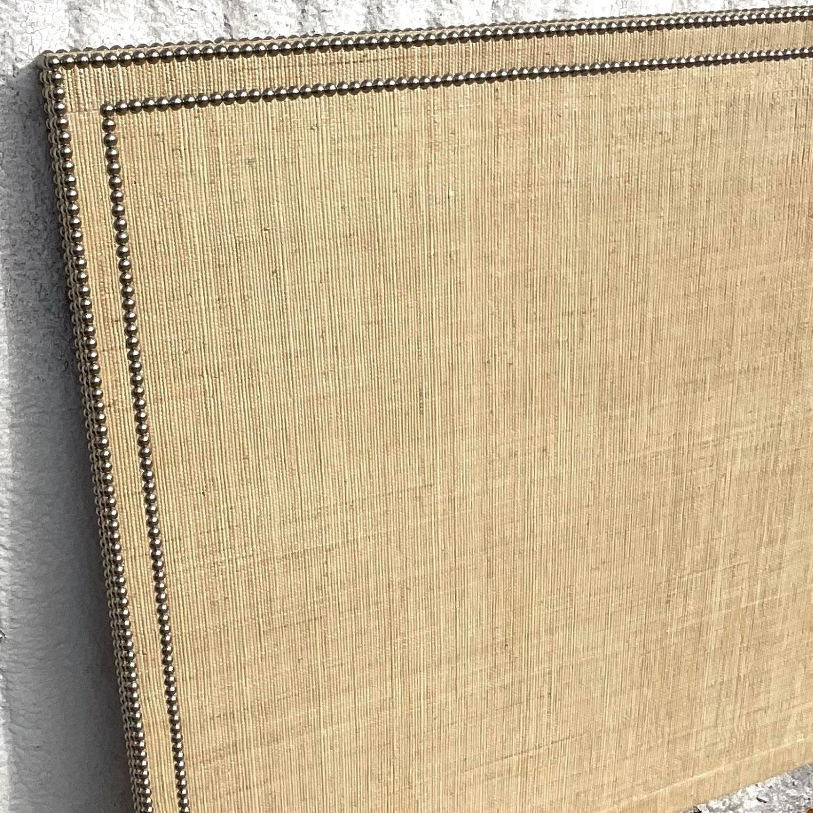 A fantastic vintage Coastal Queen headboard. A chic Grasscloth wrapped headboard with a gorgeous nailhead trim. Acquired from a Palm Beach estate.