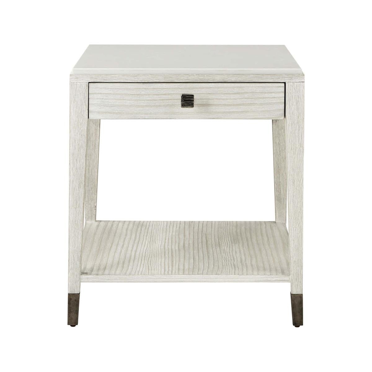 Coastal painted stone top side table, with a chalky white limestone top and base crafted from wire-brushed cerused pine in our new Sea Salt finish. This side table contains a single drawer, a lower storage shelf, and an organic ribbed metal knob