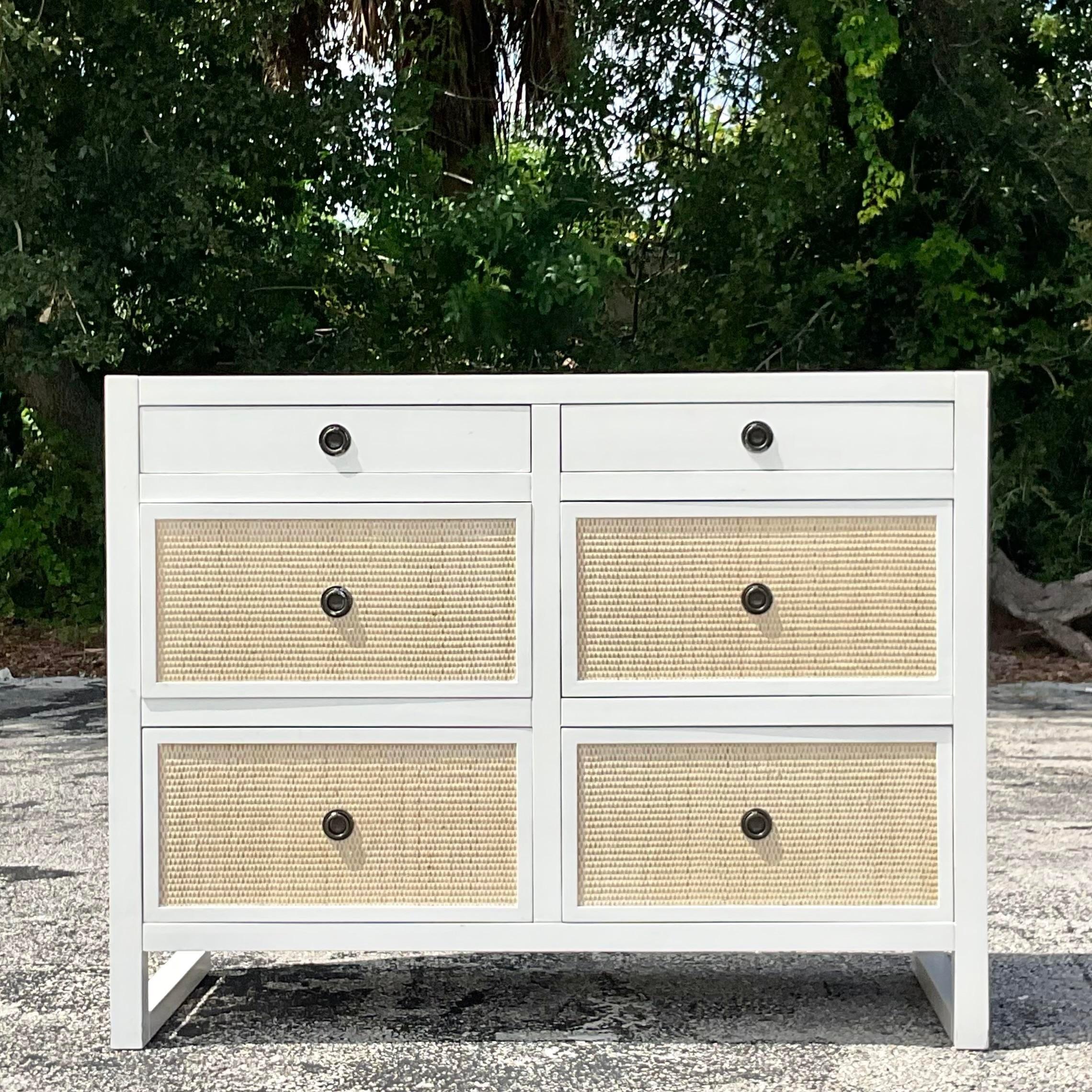 A striking vintage Coastal 6 drawer dresser. The fabulous Porter rattan dresser with a matte white lacquered cabinet with inset rattan panels. Acquired from a Palm Beach estate. 