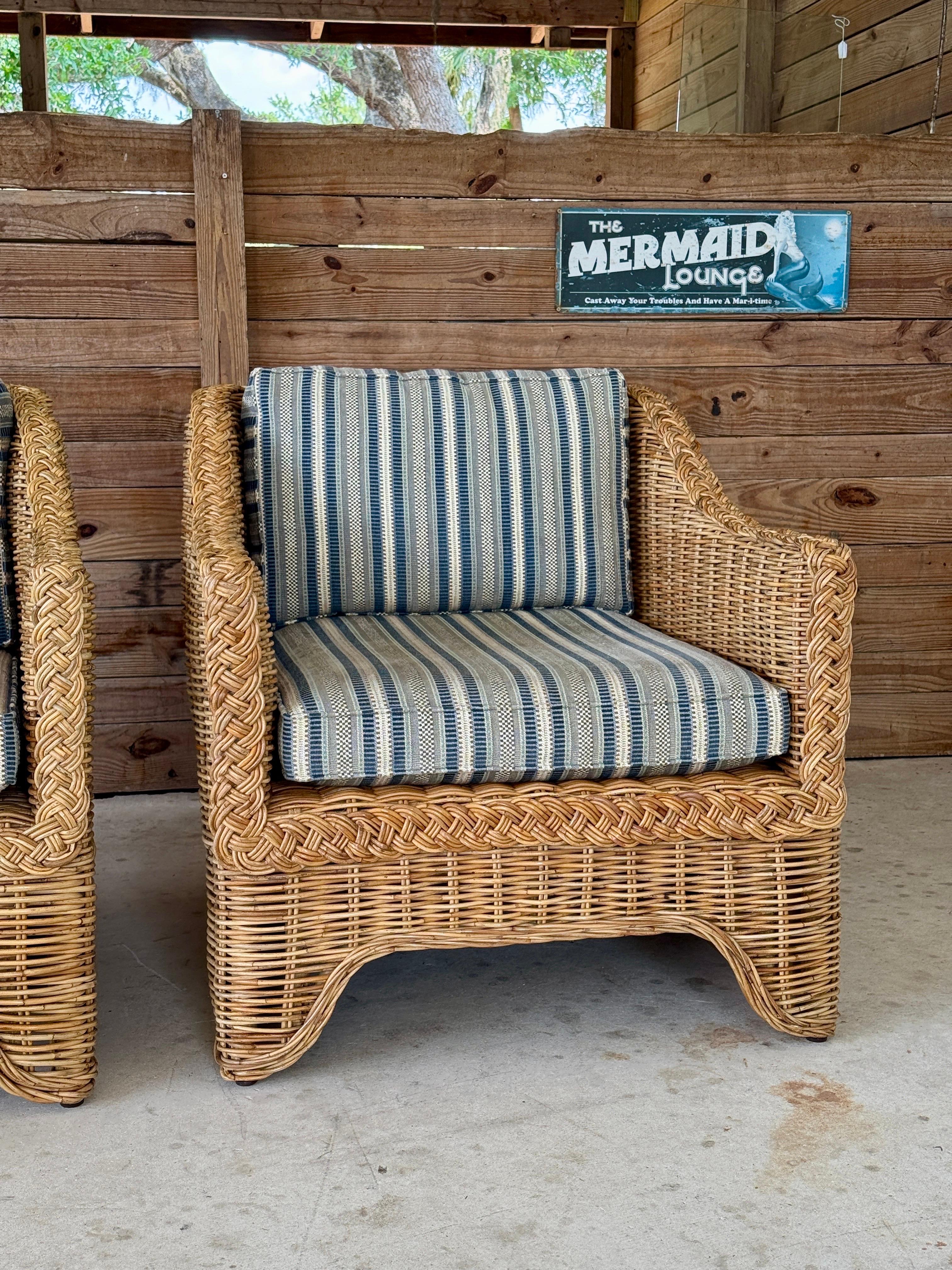 A rare and refined pair of large-scale rattan lounge chairs designed by Ralph Lauren Home for the exclusive Polo Outdoor Furniture Collection. Showcasing an intricate braid rattan frame, these substantial chairs embody the effortless, laid-back