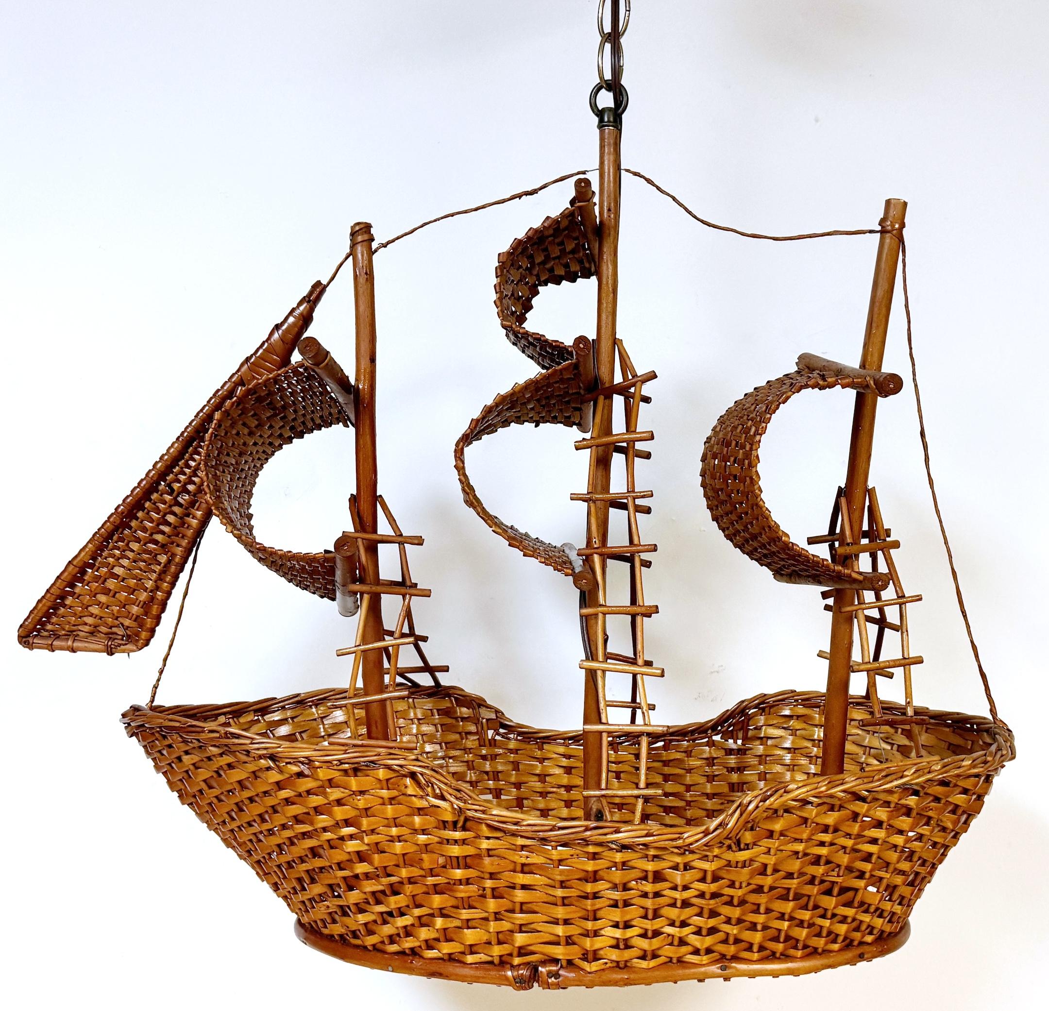 Coastal Rattan Model of a Sailing Ship Chandelier 
USA, circa 1960s

This Coastal Rattan Model of a Sailing Ship Chandelier, made in the USA circa 1960s, is a charming and unique decorative chandelier that evokes a coastal, nautical theme. Standing