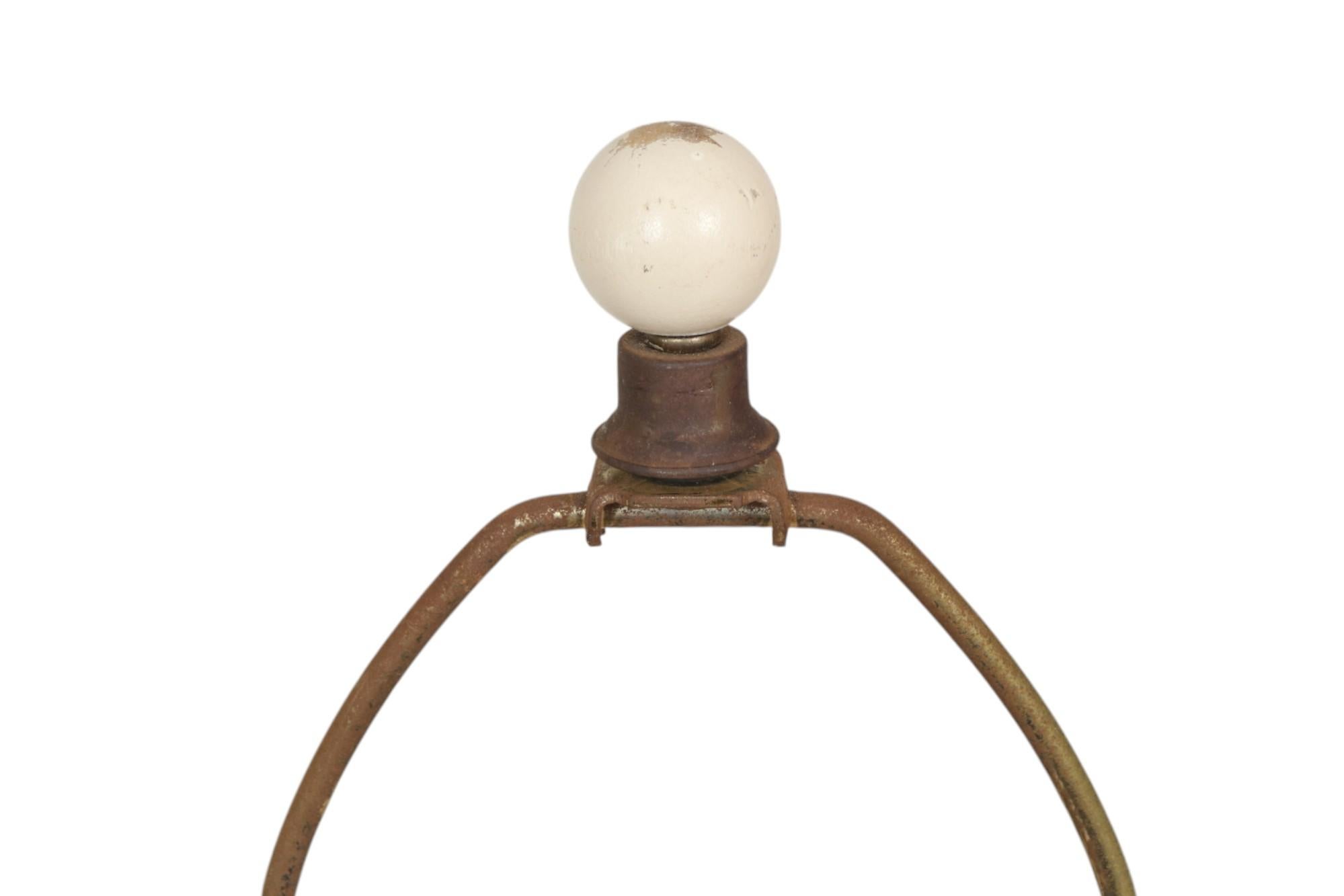 A pair of large coastal style rattan wrapped ceramic table lamps. Large cream-colored vases are wrapped at the neck and base and crossed with strips of split rattan. Harps are topped with wooden ball finials. Each lamp measures 13