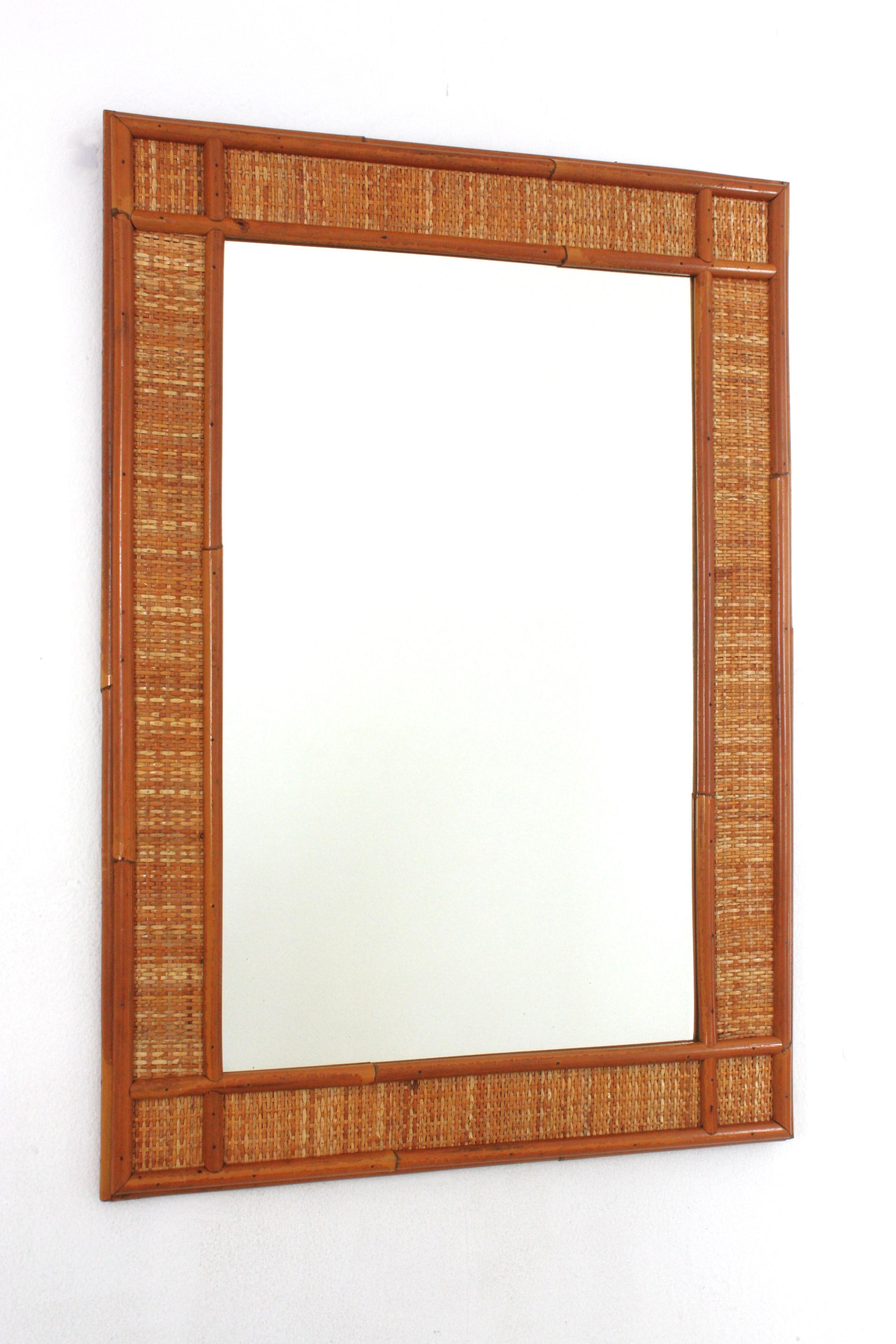 Large Rectangular Midcentury Wall Mirror framed in Rattan and Wicker, Spain, 1960-1970.
Elegant mid-20th century woven wicker and rattan mirror. Cross details on the corners. Eye-catching coastal design with all the taste of the Italian Riviera,