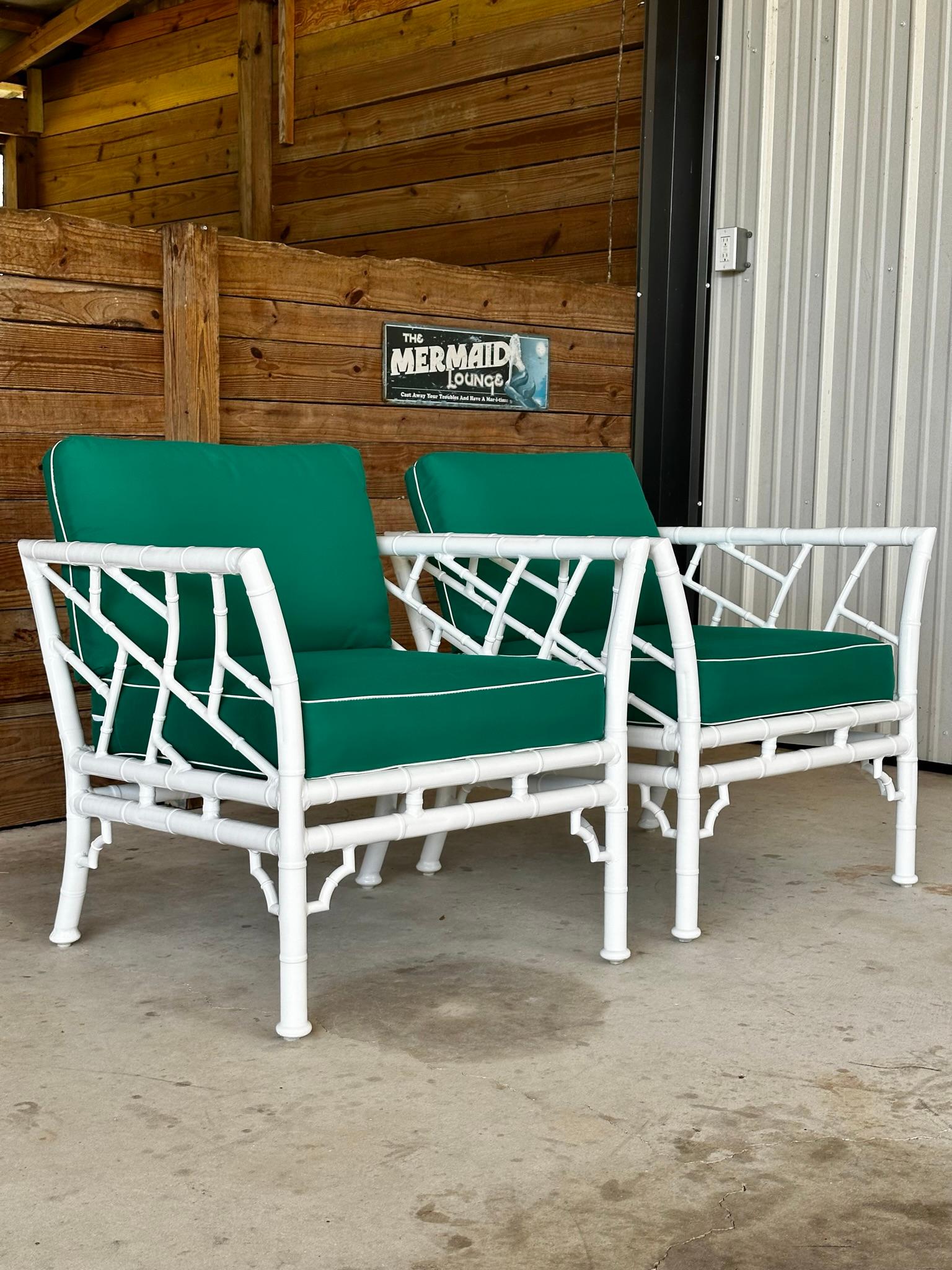 Presenting a fabulous pair of vintage aluminum faux bamboo lounge club chairs, expertly crafted by Meadowcraft. These chairs have been previously powder coated in a crisp white finish and upholstered in a charming jade green fabric. While the fabric