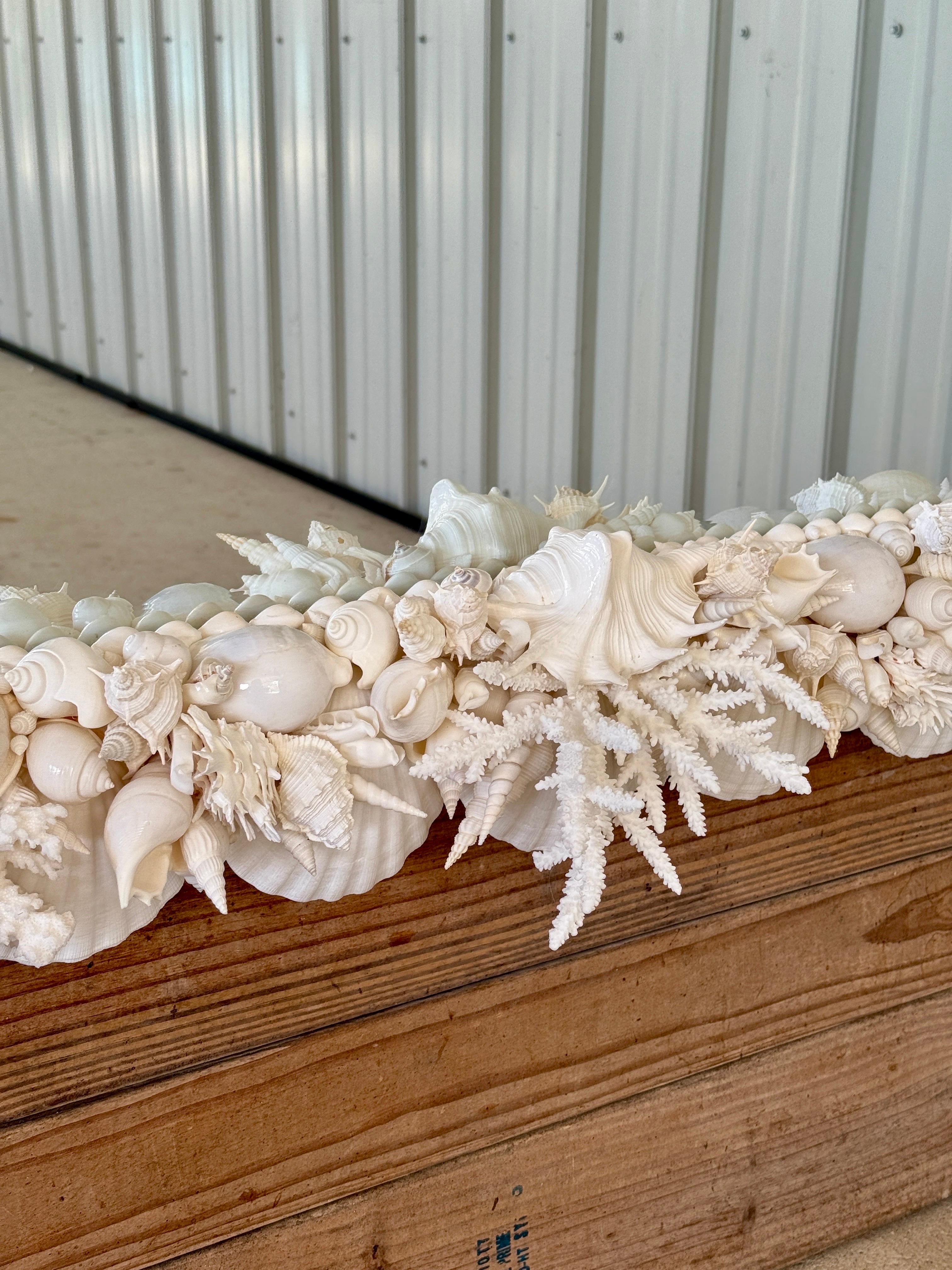 A mesmerizing, one-of-a-kind monumental seashell mirror, exquisitely handcrafted with an intricate symphony of natural shells, coral, and marine-inspired elements.

This bespoke masterpiece showcases a lavishly layered design, its sculptural frame