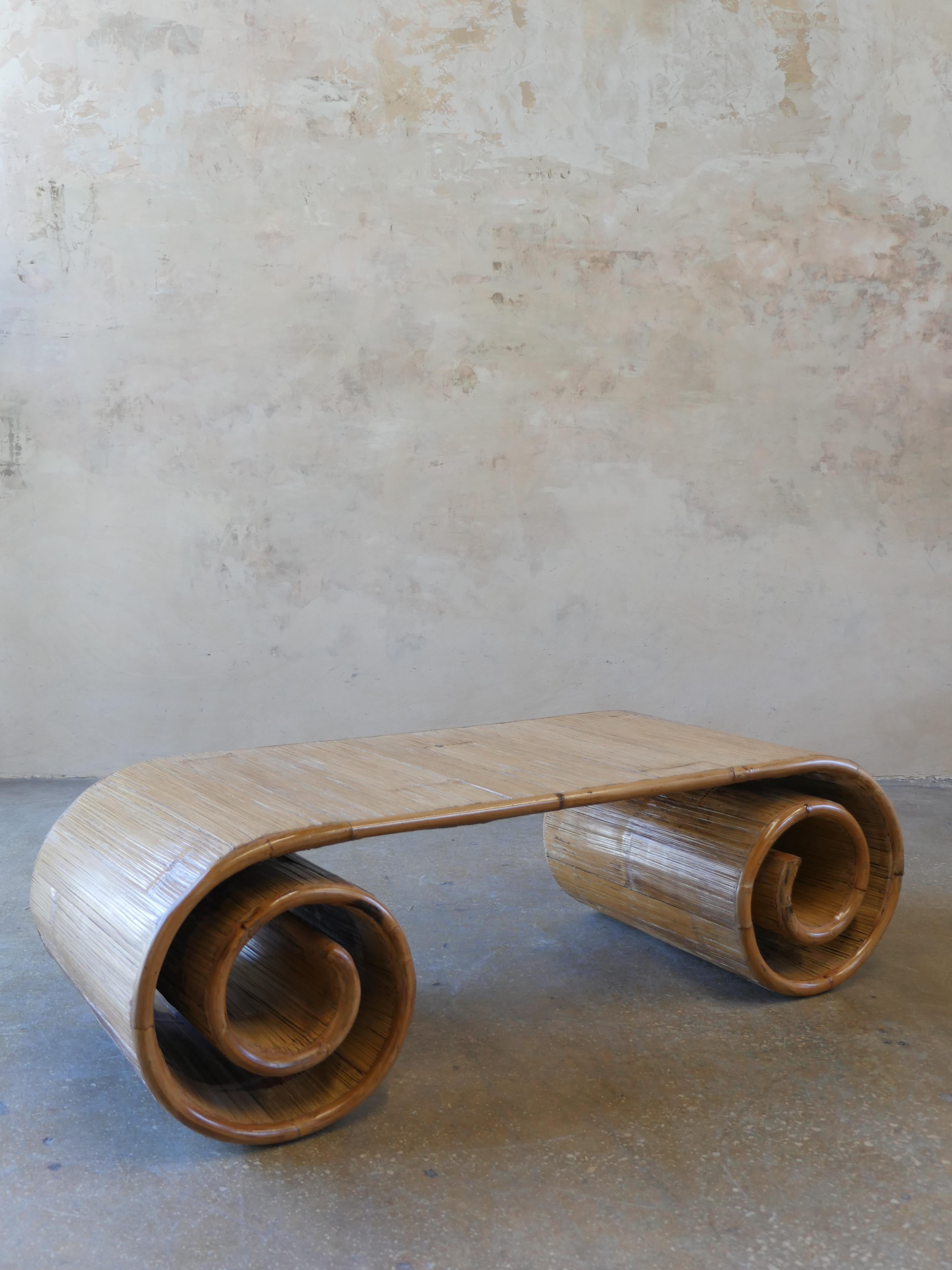 Monumental vintage, split-reed bamboo scroll coffee table. This beautiful mid-century coffee table, is full of warmth and character and is sure to be the topic of discussion in any room.