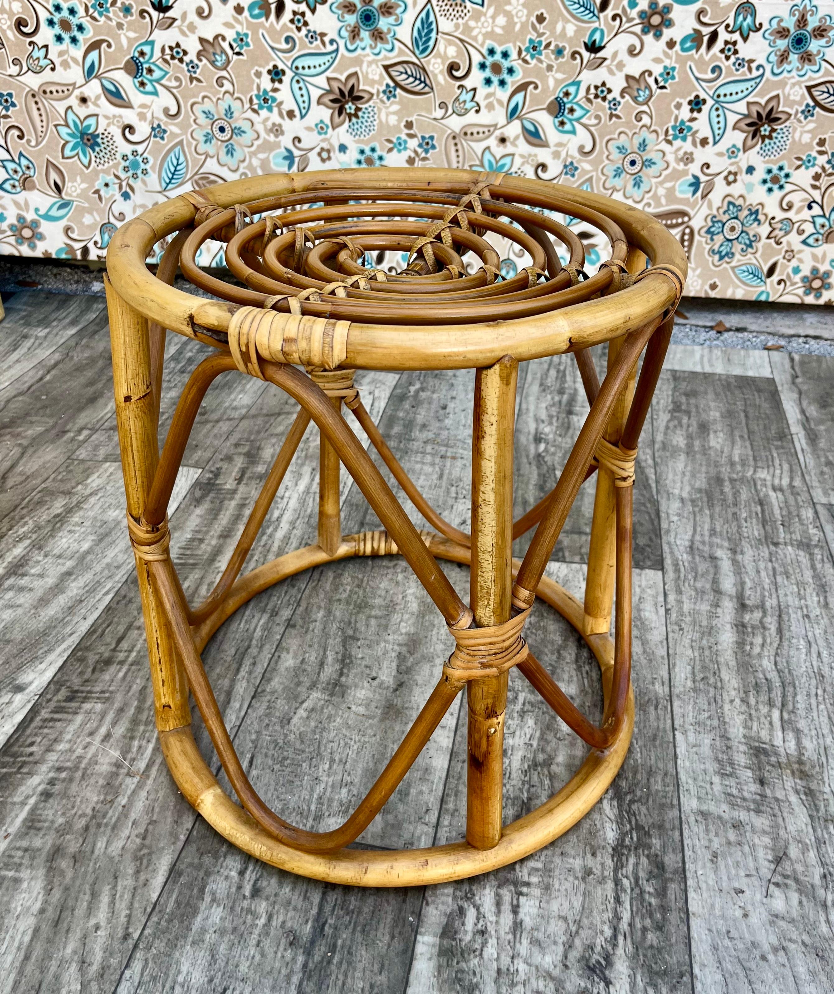 Vintage Coastal Style / Bohemian  Bamboo and Rattan Round Side Table or Stool in the Franco Albini Manner.  Circa 1970s
Features a gracefully bent rattan frame and the perfect size for a lightweight side table or plant stand.
In excellent original
