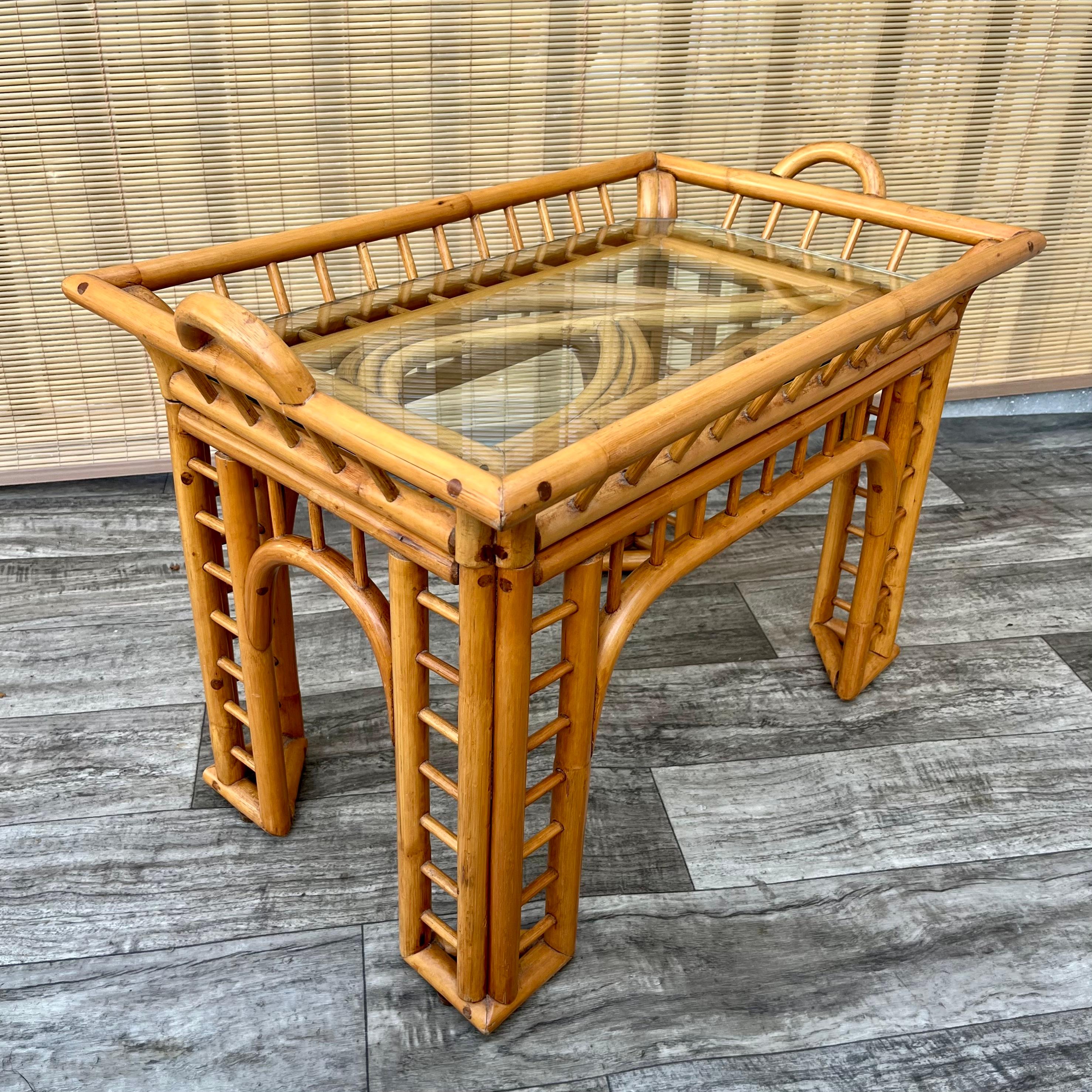 Vintage Mid Century Modern Coastal Style Bent Rattan Side Table with Removable Tray by Whitecraft Rattan Inc, Miami FL. Circa 1970s 
Features a bent rattan frame with an intricate and dynamic fluid design and removable serving tray. 
In excellent
