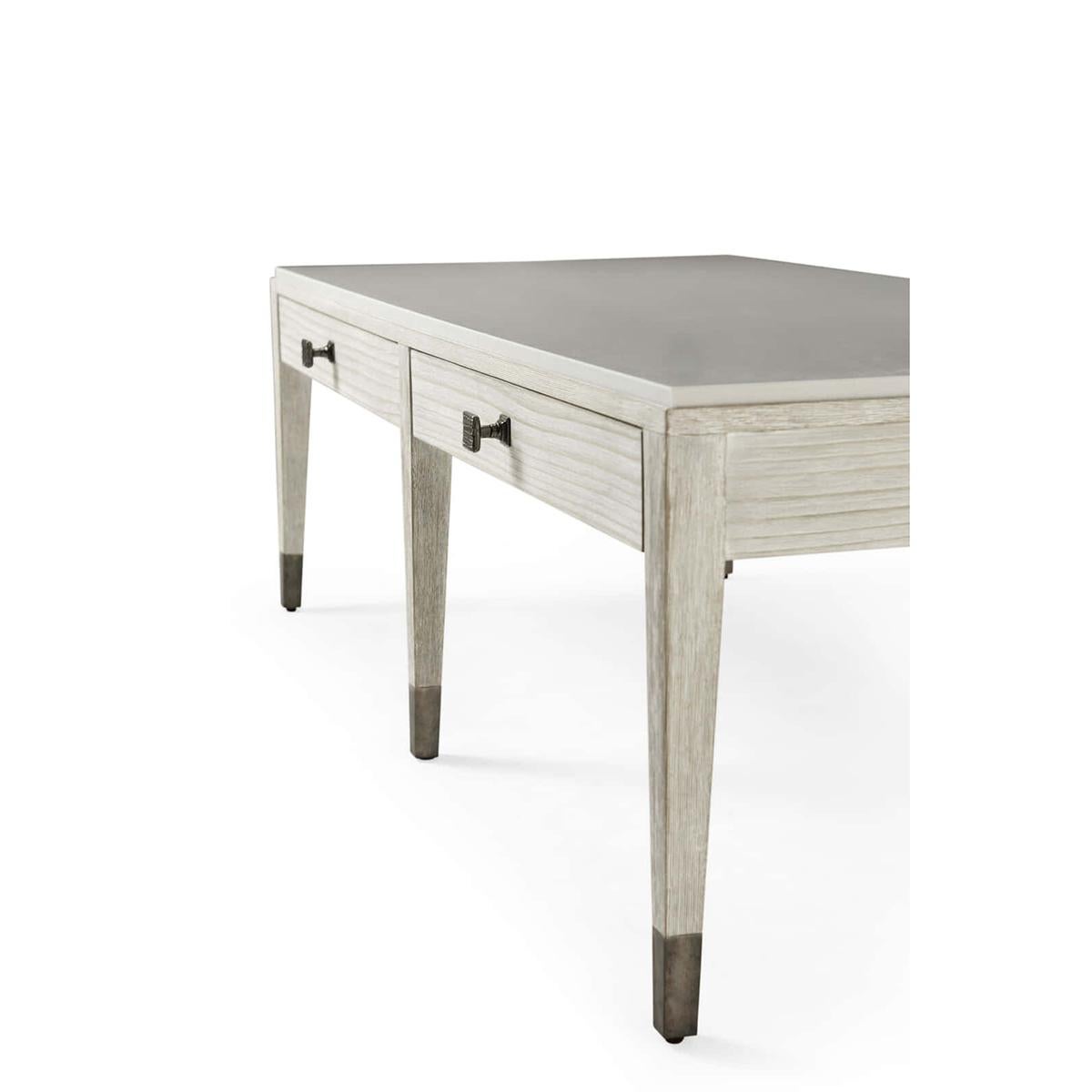 A Coastal style cocktail table, with two drawers, a cerused pine table with a chalky white cast limestone top and two organic ribbed metal knobs in our dark sterling finish.

Dimensions: 58