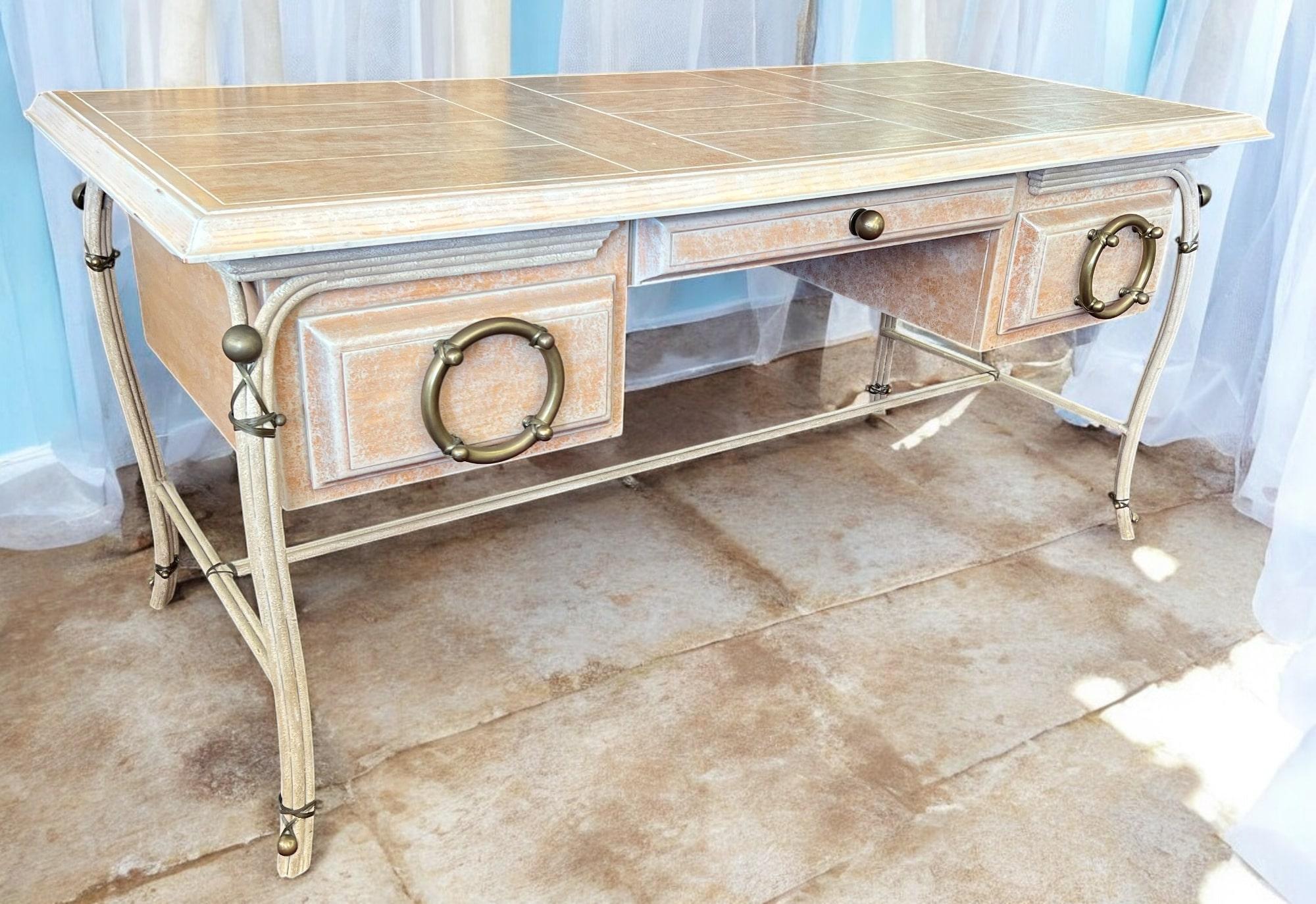 A coastal style desk by Designer Charles Hart. The desk's textured finish evokes the feel of sand on the beach, and the unique drawer pulls, reminiscent of classic ship wheels, add a touch of nautical charm. While ideal for a seaside office, this