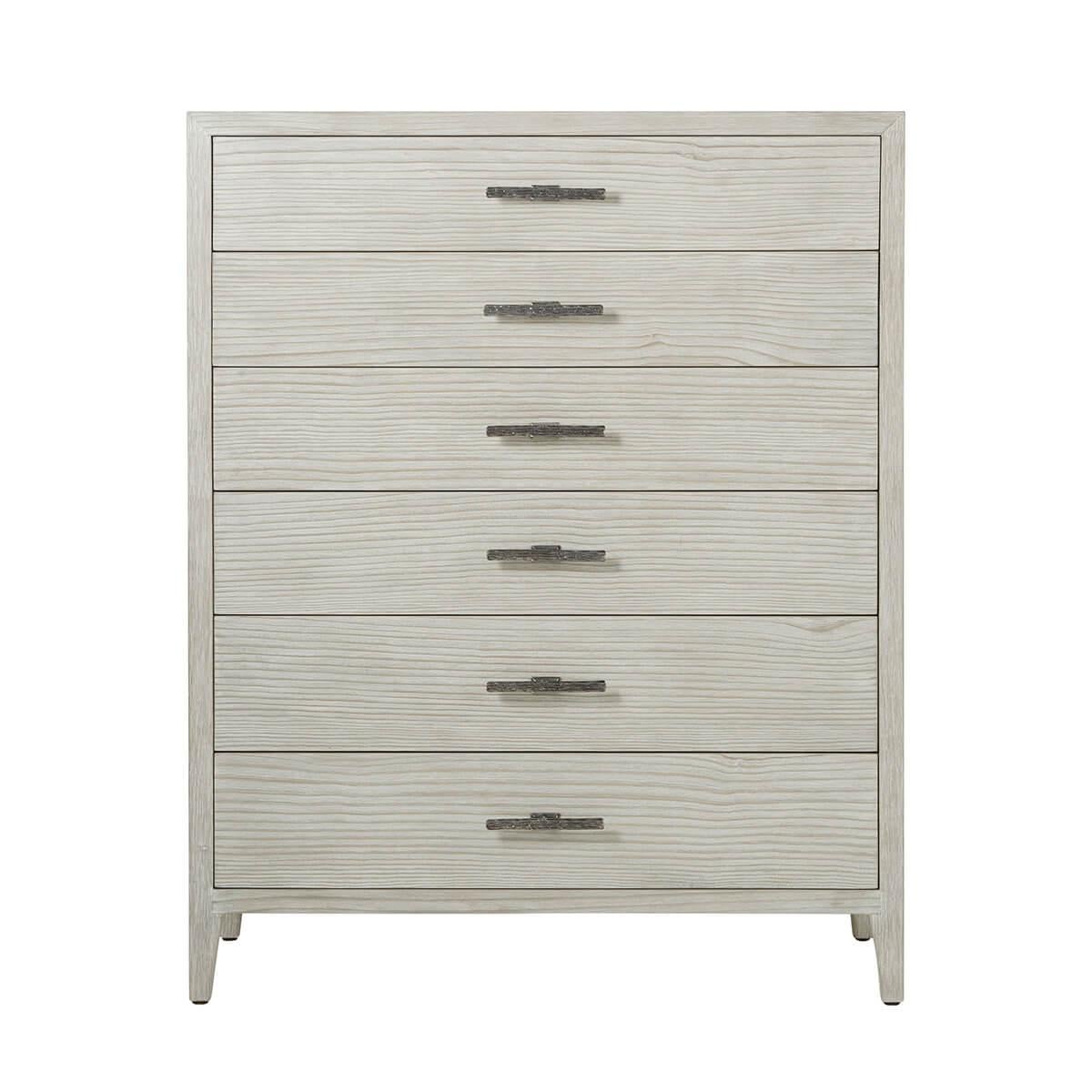 A modern take on a classic silhouette, the tall dresser is painted in the Sea Salt finish and accented with ribbed cast hardware in a dark sterling finish, with six soft closing drawers and raised on tapered legs.

Dimensions: 44