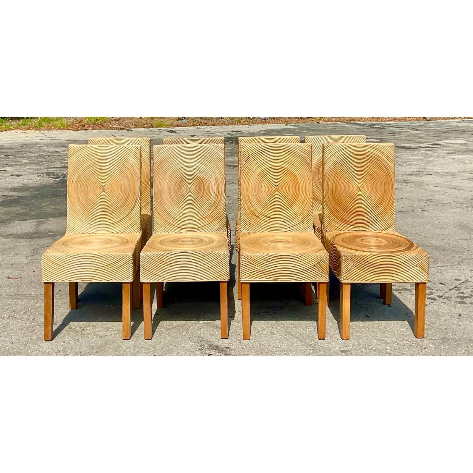 Vintage Coastal set of 8 pencil reed dining chairs. Iconic circular design with a pale reed finish. A really special and unique set. Acquired from a Palm Beach estate.