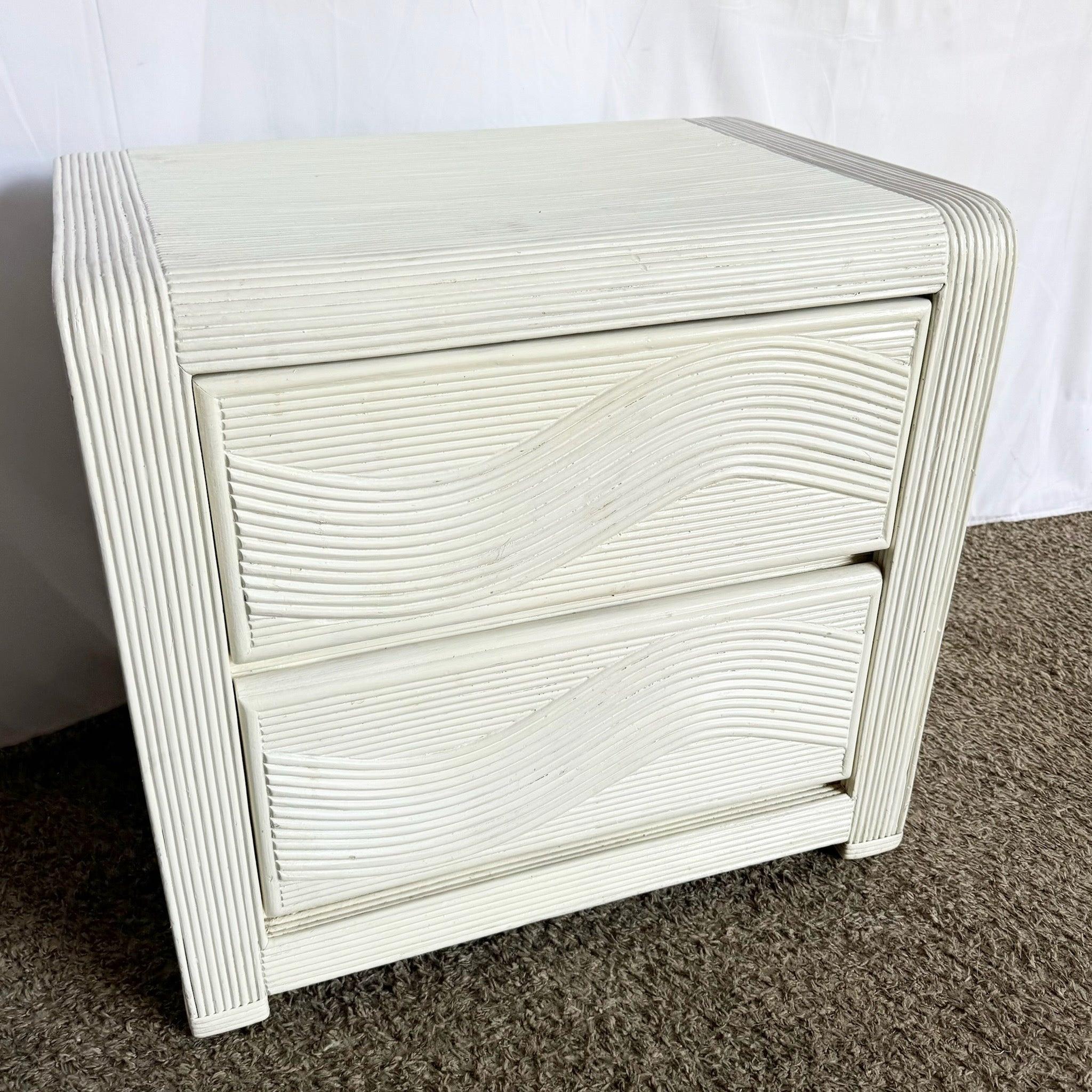 Coastal White Wavy Pencil Reed Nightstand—sculpted silhouette with undulating detailing adds breezy sophistication to any space.​
 
 We sell items as acquired, without restoring or repairing. Vintage pieces may have age-related wear. Review photos