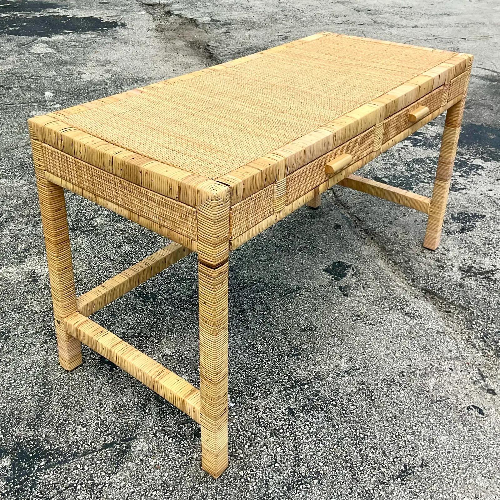 A fabulous Contemporary Coastal writing desk. Beautiful wrapped rattan frame with inset woven rattan panels. Acquired from a Palm Beach estate.