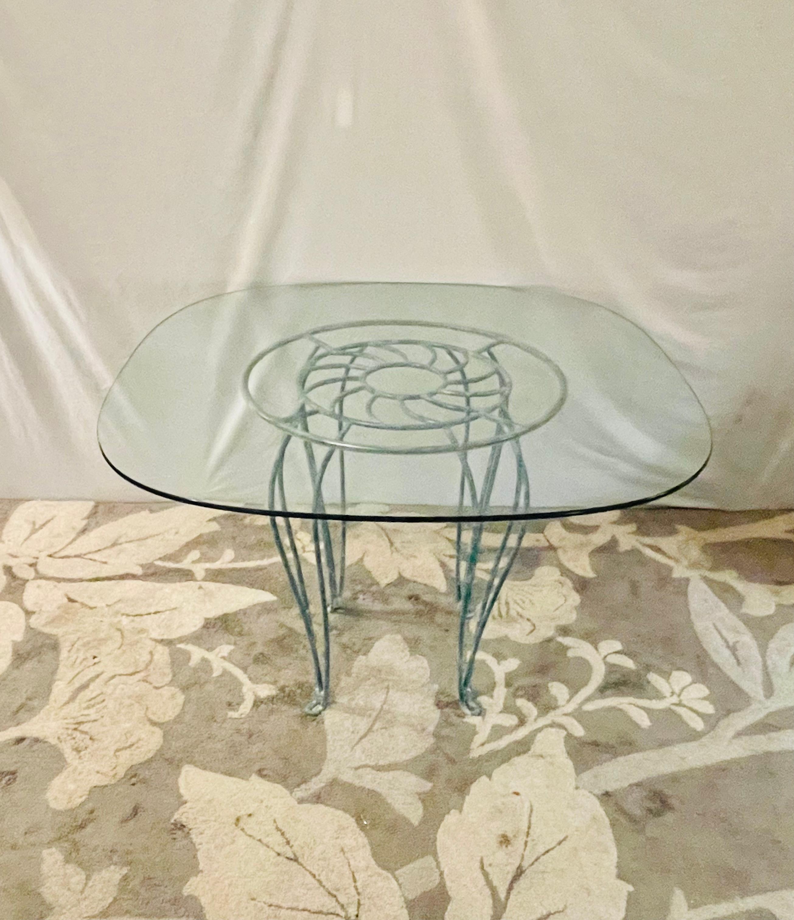 Available now and ready to ship is a Coastal Wrought Iron Seashell Table featuring a flaw free 1/2 inch glass top. Beautiful Green Wrought Iron with Seashell in the middle and curved legs. Glass sits on top with protective covering. 

4 Seashell