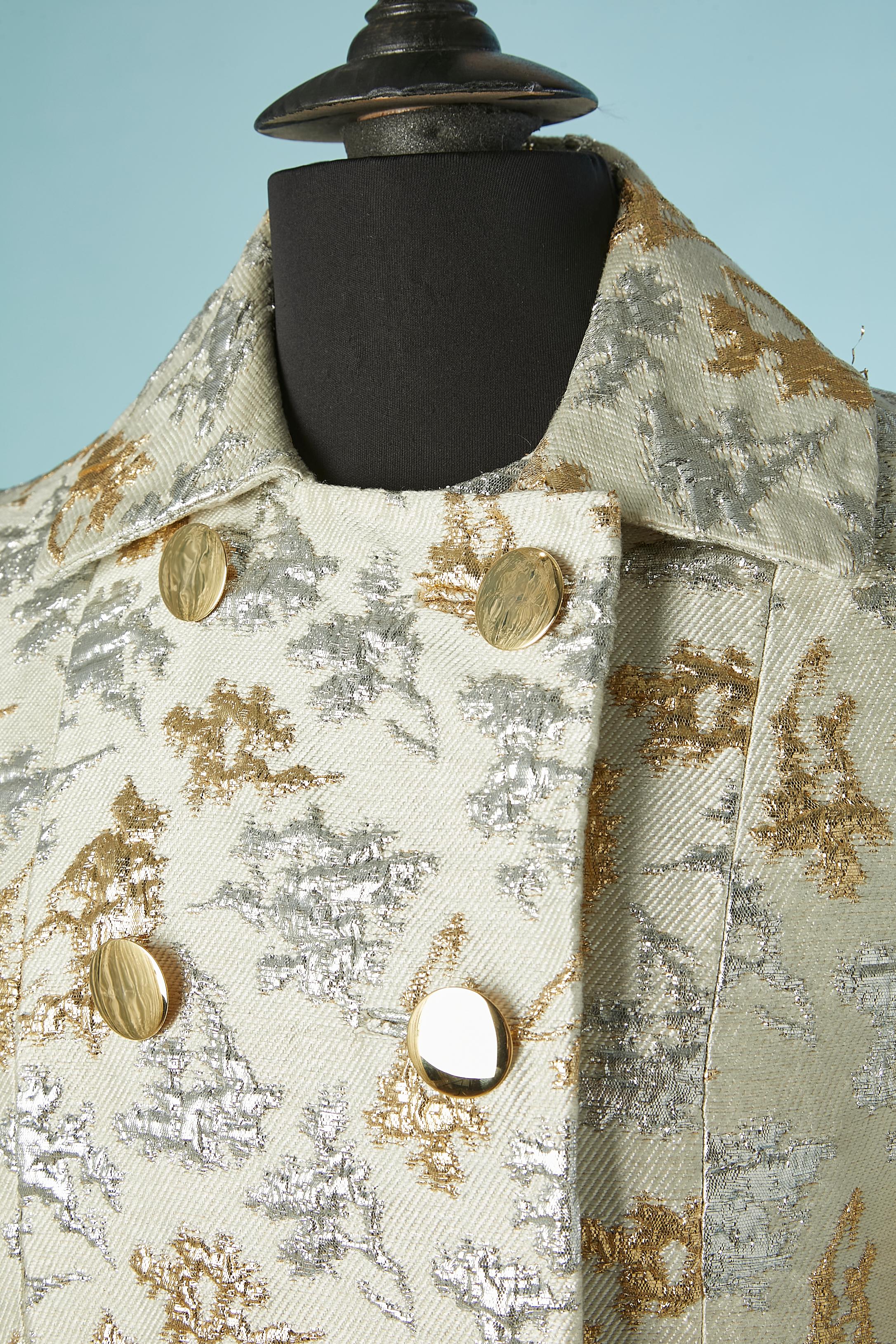 Coat and dress silver and gold brocade ensemble. No fabric composition tag but the lining is probably made of acetate or rayon. 
Gold metal decorative buttons with hidden snap closure underneath.
Pocket flap with gold button but the opening of the