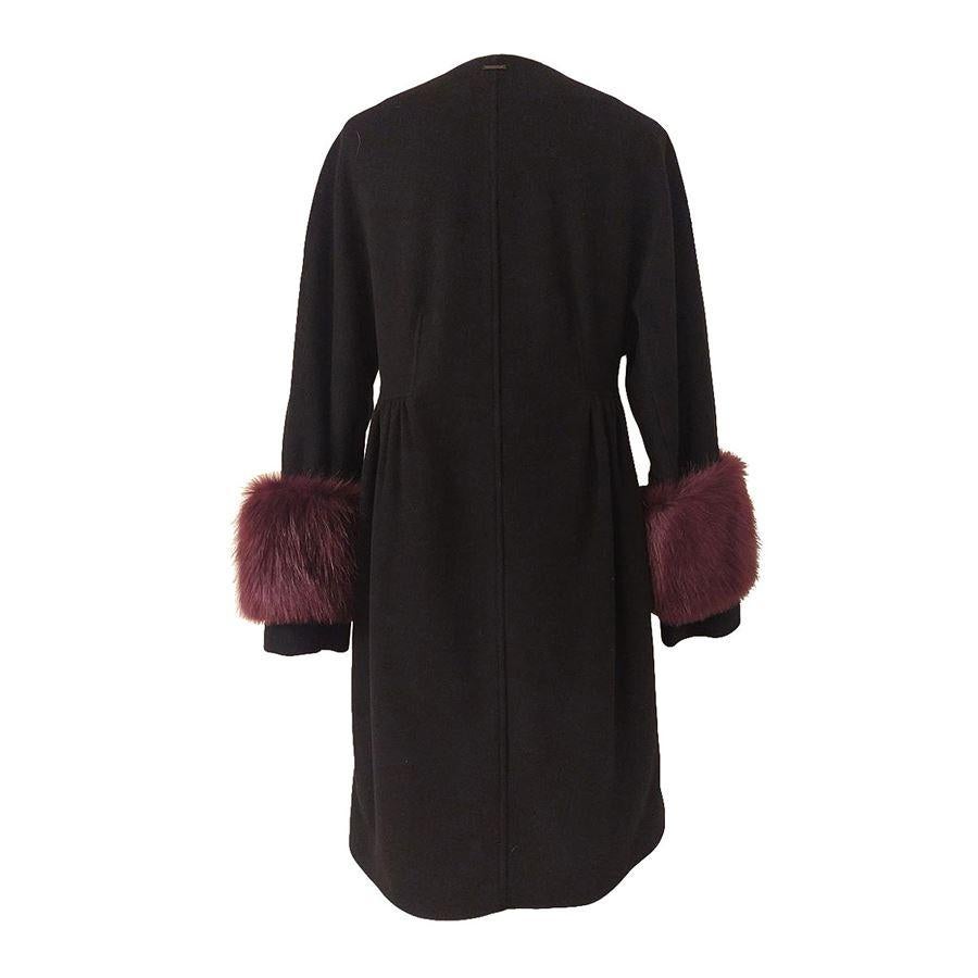 Virgin wool(70%) Polyamide (20%) Cashmere Black color Long sleeves Removable purple eco fur details on wrists Two pockets Automatic buttons closure Length shoulder / hem cm 93 (3661 inches)

