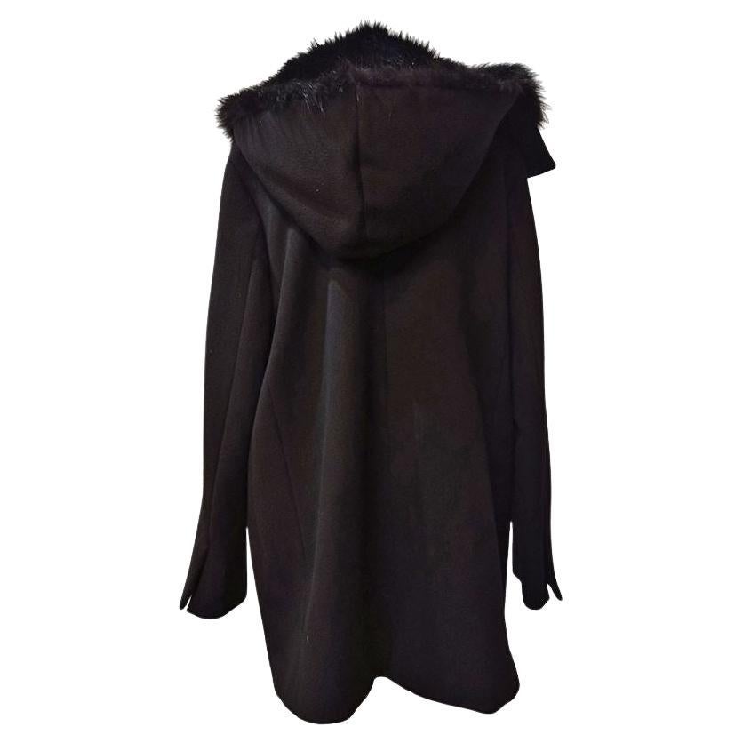 Virgin wool (95%) Cashmere (5%) Real fox and racoon fur inserts Black color Long sleeves Two pockets Ribbons closure With detachable hoodie Length shoulder / hem cm 80 (3149 inches) Shoulders cm 44 (1732 inches)
