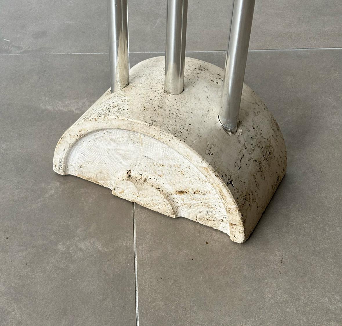 The coat hanger by Fratelli Mannelli, crafted in 1970s Italy, is a striking example of functional design paired with minimalist elegance. Featuring a solid travertine base, this piece showcases the enduring appeal of natural stone, which contrasts