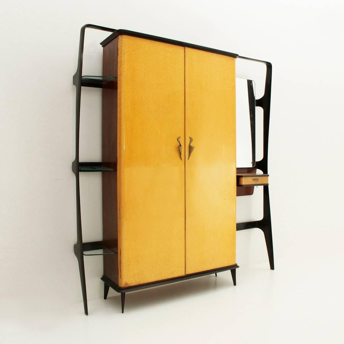 1950s coat rack made by Consorzio Esposizione Mobili Cantù.
Composed of a black-stained wooden frame of modernist forms.
A veneered wood wardrobe, briarwood veneered doors and brass handles. Lower edge, upper and legs in black stained wood. Inside