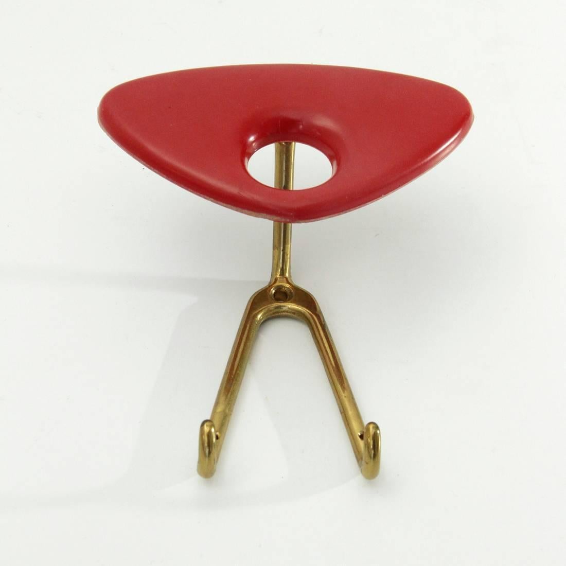 Coat hanger of Italian manufacture produced in the 1950s.
Brass structure and red plastic
Good general conditions.

Dimensions: Width 13.5 cm, depth 7 cm, height 15 cm.
