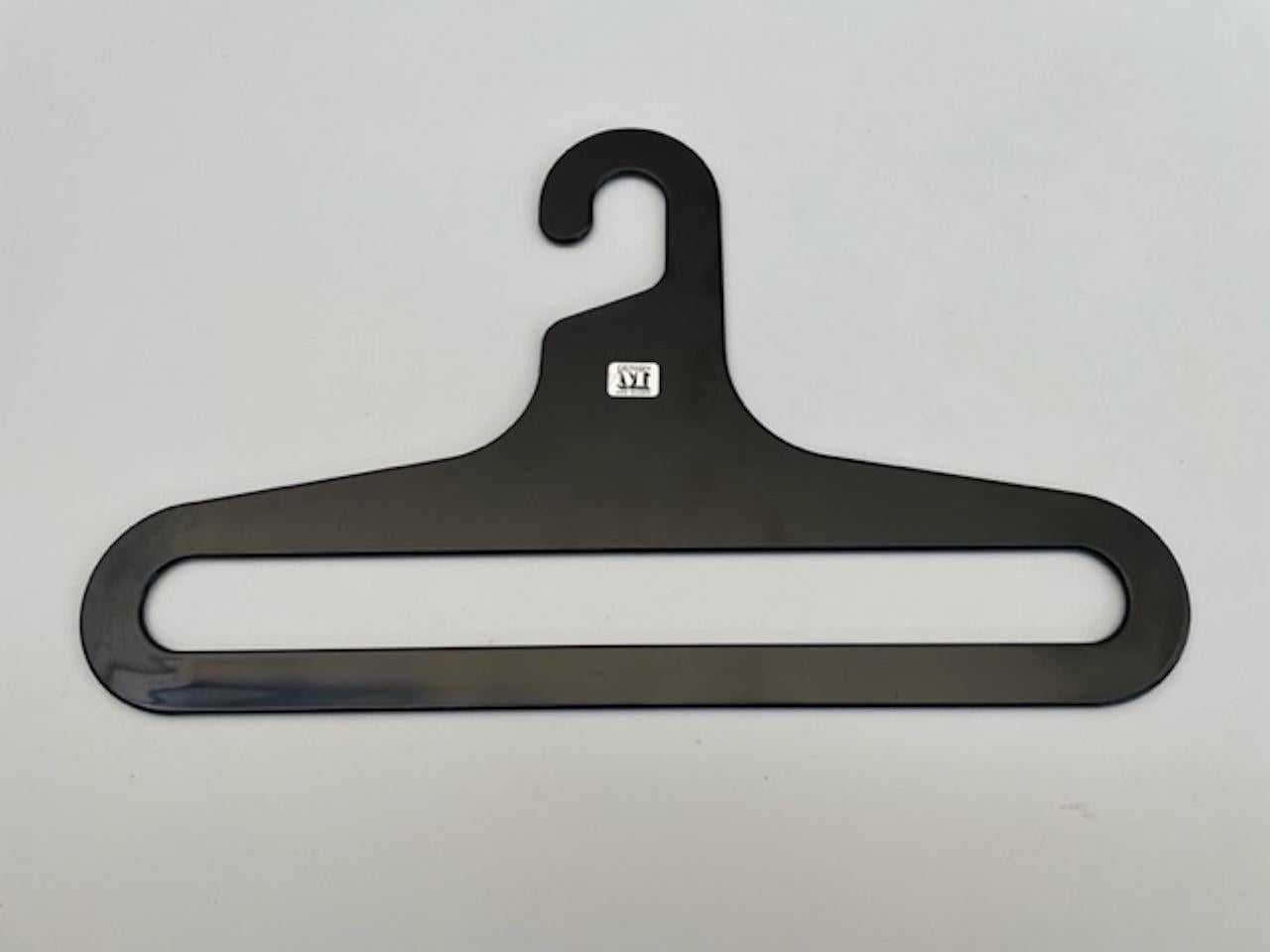 Set of 12 beautiful clothes hangers in refined black lacquered plastic. Originals from the early 80s perfectly reflect the style and signature of their creator. Elegant and soft design, they maintain their elegance and modernity over time. The