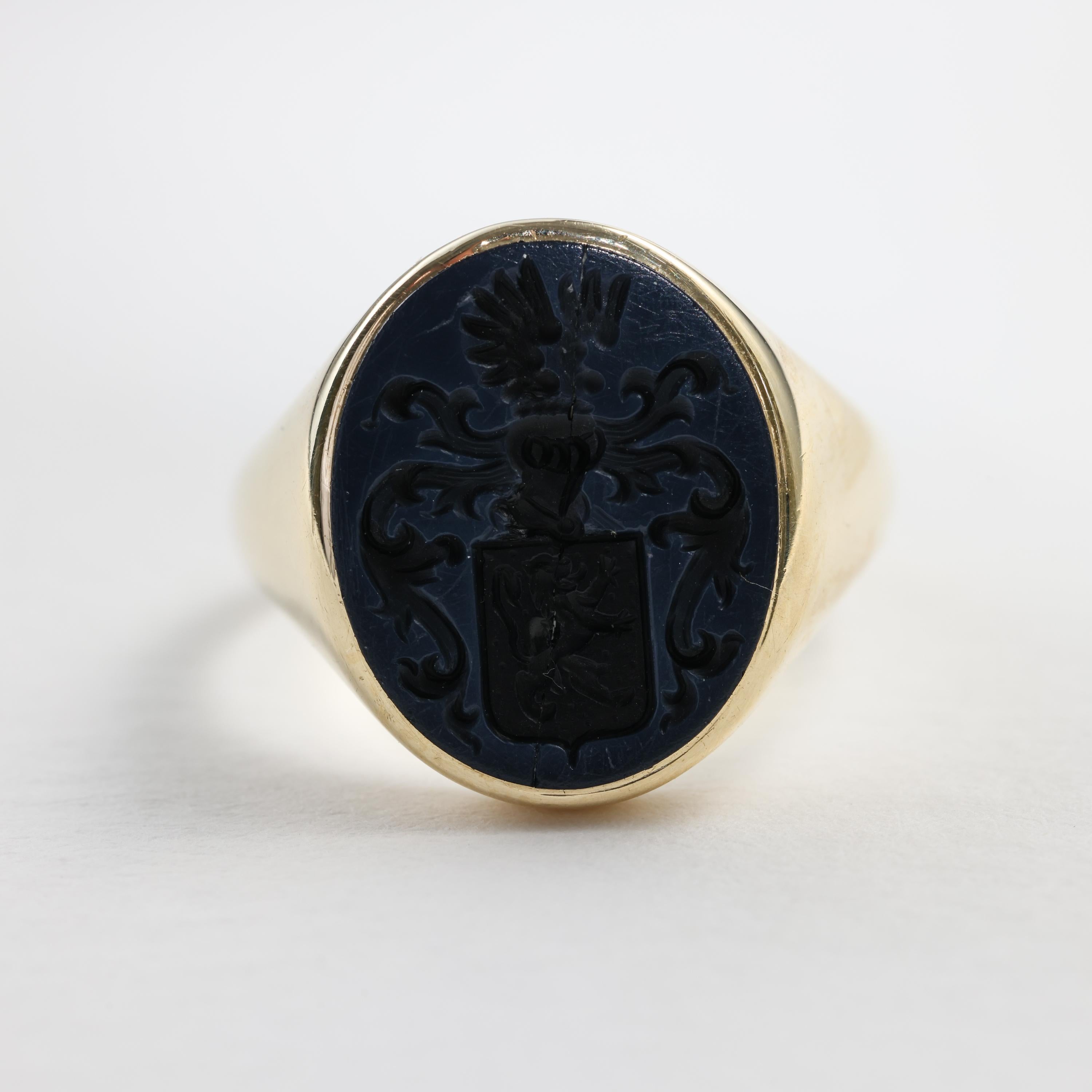 This Victorian-era deeply engraved family crest intaglio signet ring is crafted from 18K gold and agate. The interior bears marks too worn to read, but the gold was tested and the ring made in England.

The ring is simultaneously understated and