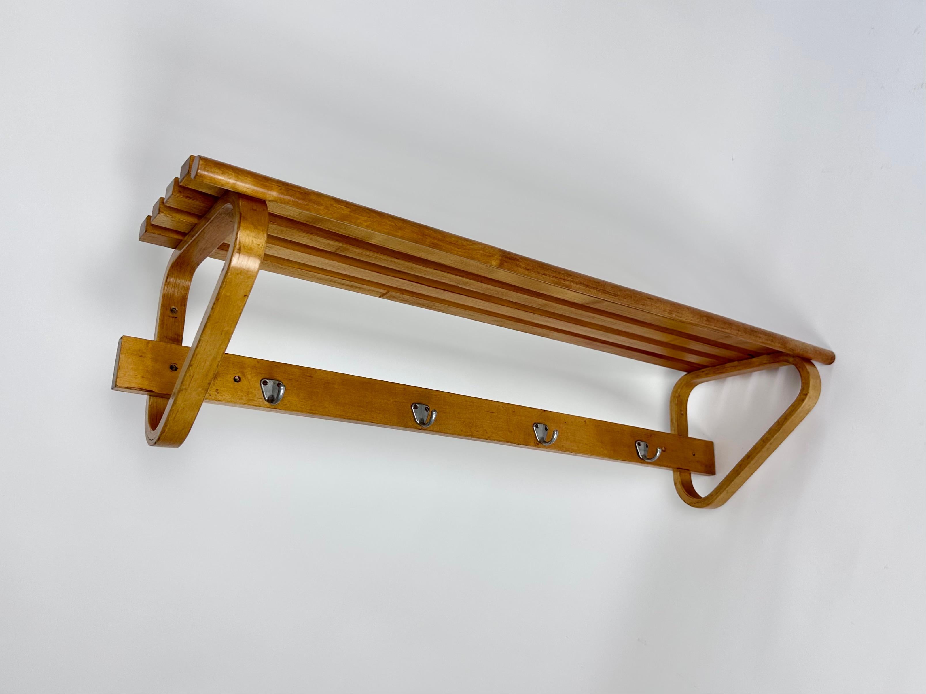 Perfectly aged coat rack, model 109c designed by Alvar Aalto in 1936, Artek Finland production.

Made of Aalto trademark rounded triangle bent ply birch supports (which were also used on other pieces), solid birch slatted shelf and rounded bar for