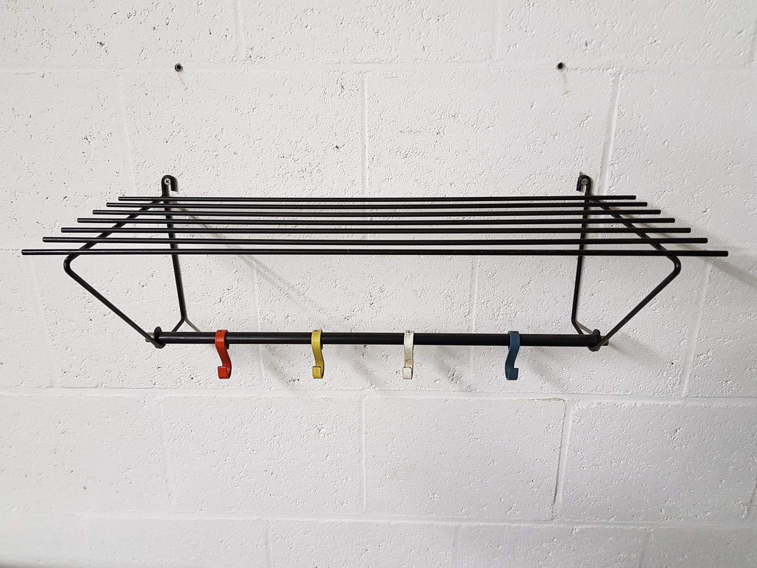 Dutch minimal coatrack attributed to Mathieu Matégot for Artimeta.

Beautiful metal coat rack with coloured coat hooks and a place on top to store your hat, gloves or shawl.

We found this coat rack in an Old Dutch mansion. The owners bought it