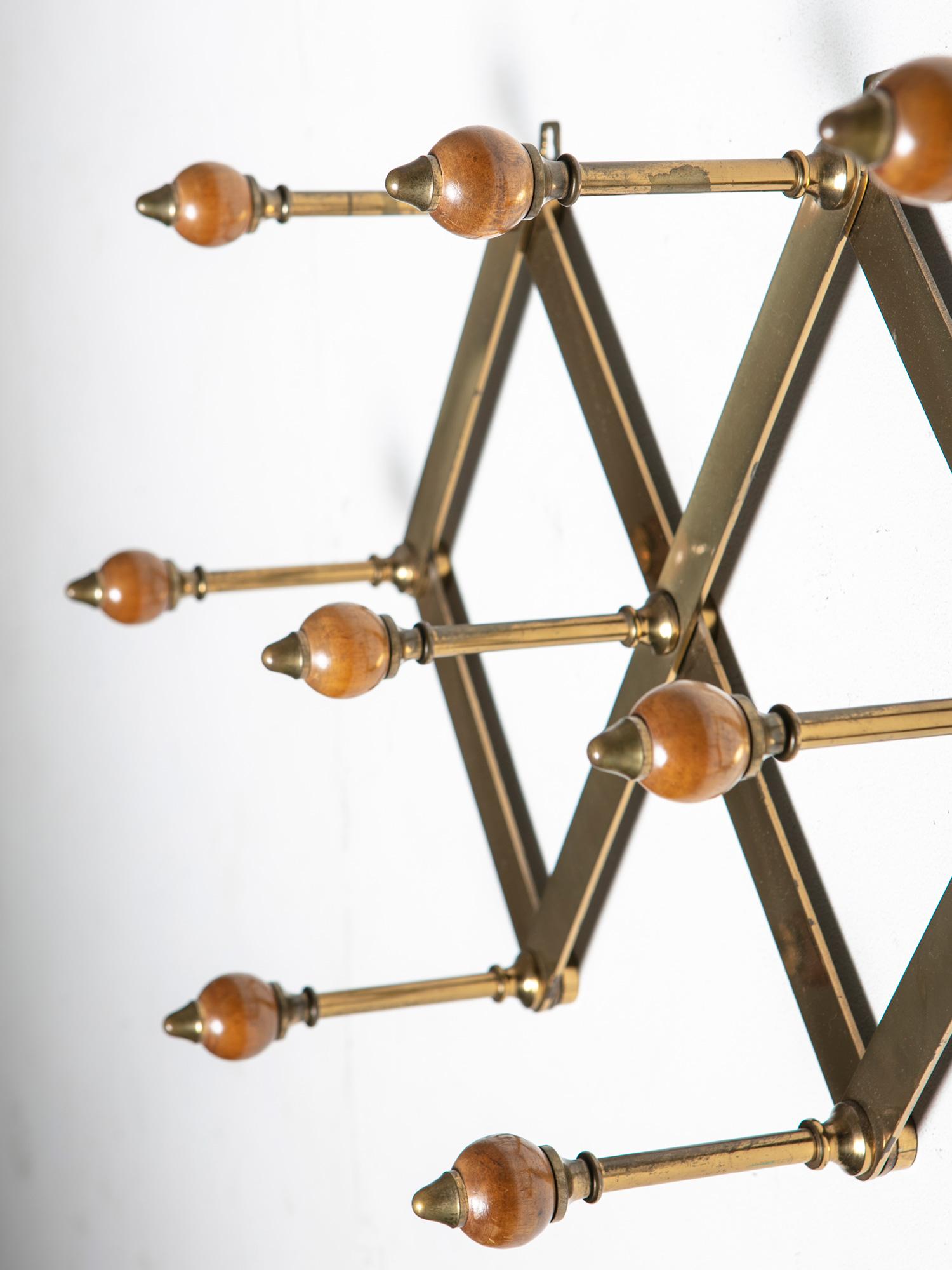 Expandable coat rack by Luigi Caccia Dominioni for Azucena.
Pantograph brass frame and polished wood spheres.