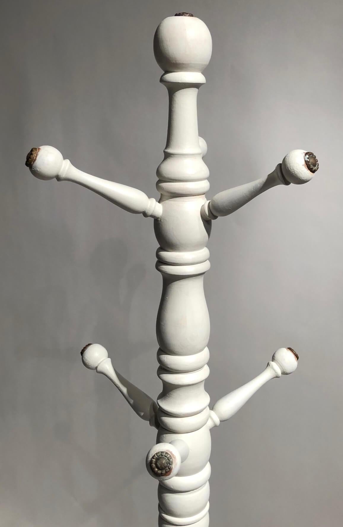 Last quarter 19th century Scottish coat and hat rack, hall tree, or hall stand having painted and turned standard issuing six turned pegs with bead-stamped brass caps connecting to base with turned disk collar atop four carved deer leg and hoof