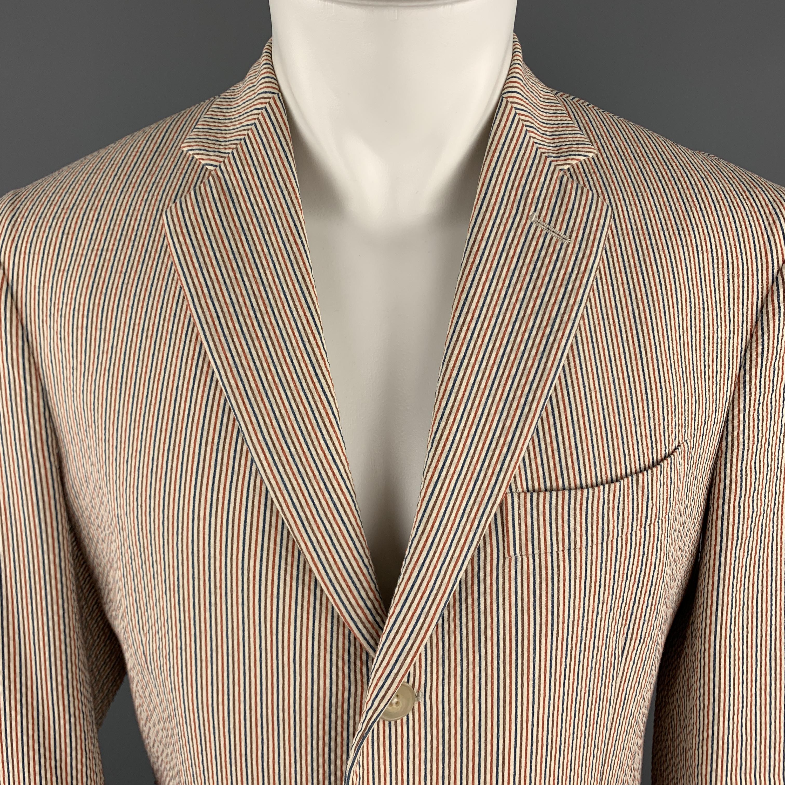 COAT sport coat comes in beige cotton blend Seersucker with a red, blue, and brown stripe pattern throughout, a notch lapel, single breasted, three button front, and double vented back. Made in Italy.

Excellent Pre-Owned Condition. 
Marked: IT