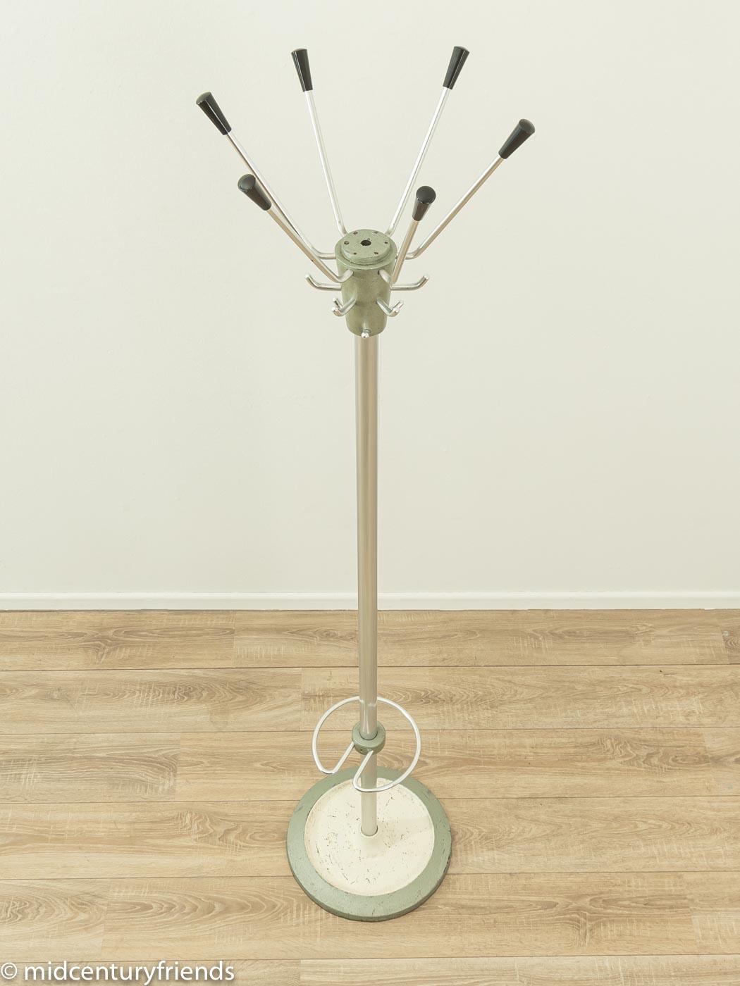 Wonderful coat stand from the 1960s. High-quality frame made of stainless steel with six hooks, an umbrella holder and a metal base. Made in Germany.