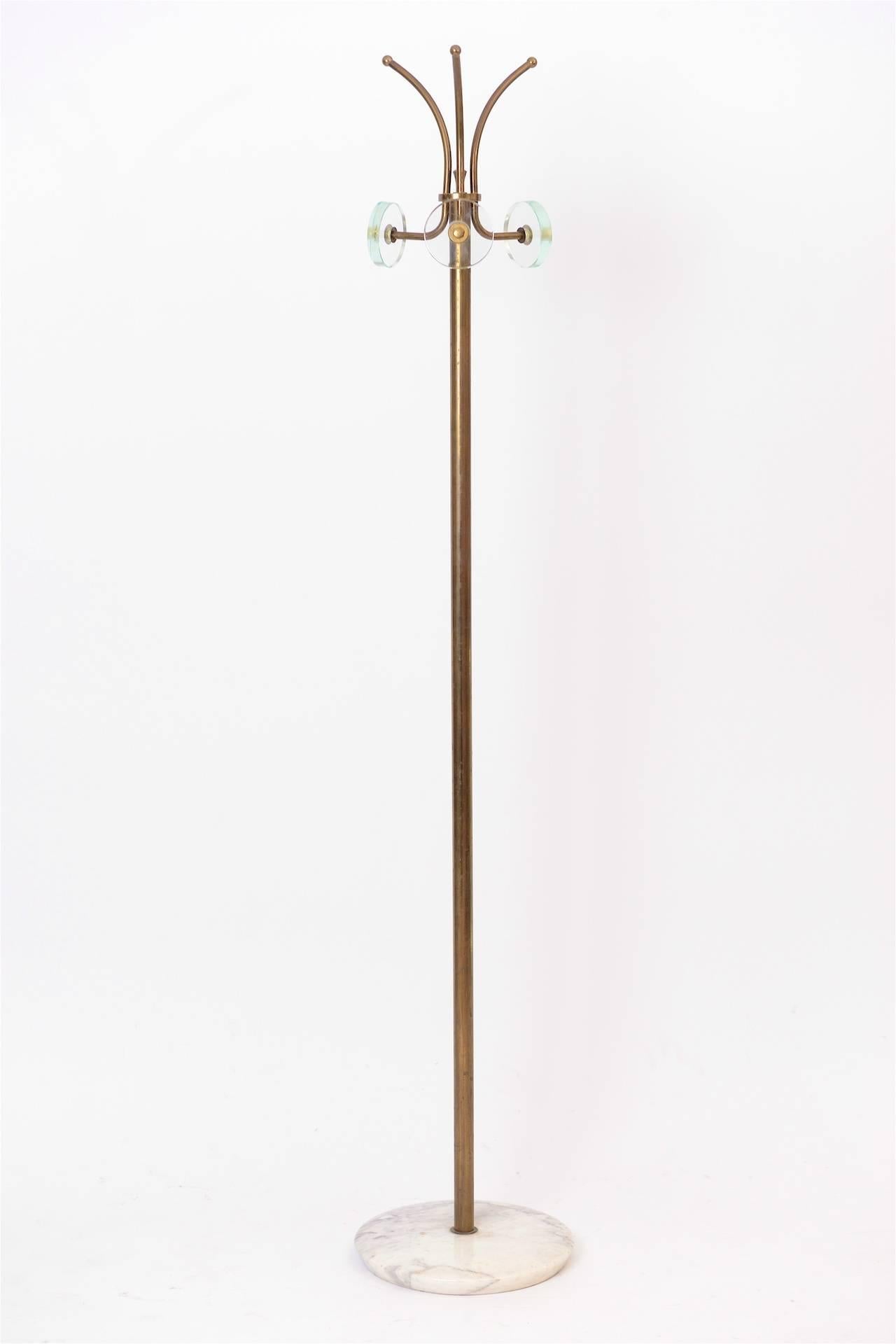 Coat stand in in brass and glass with a marble base.
 
