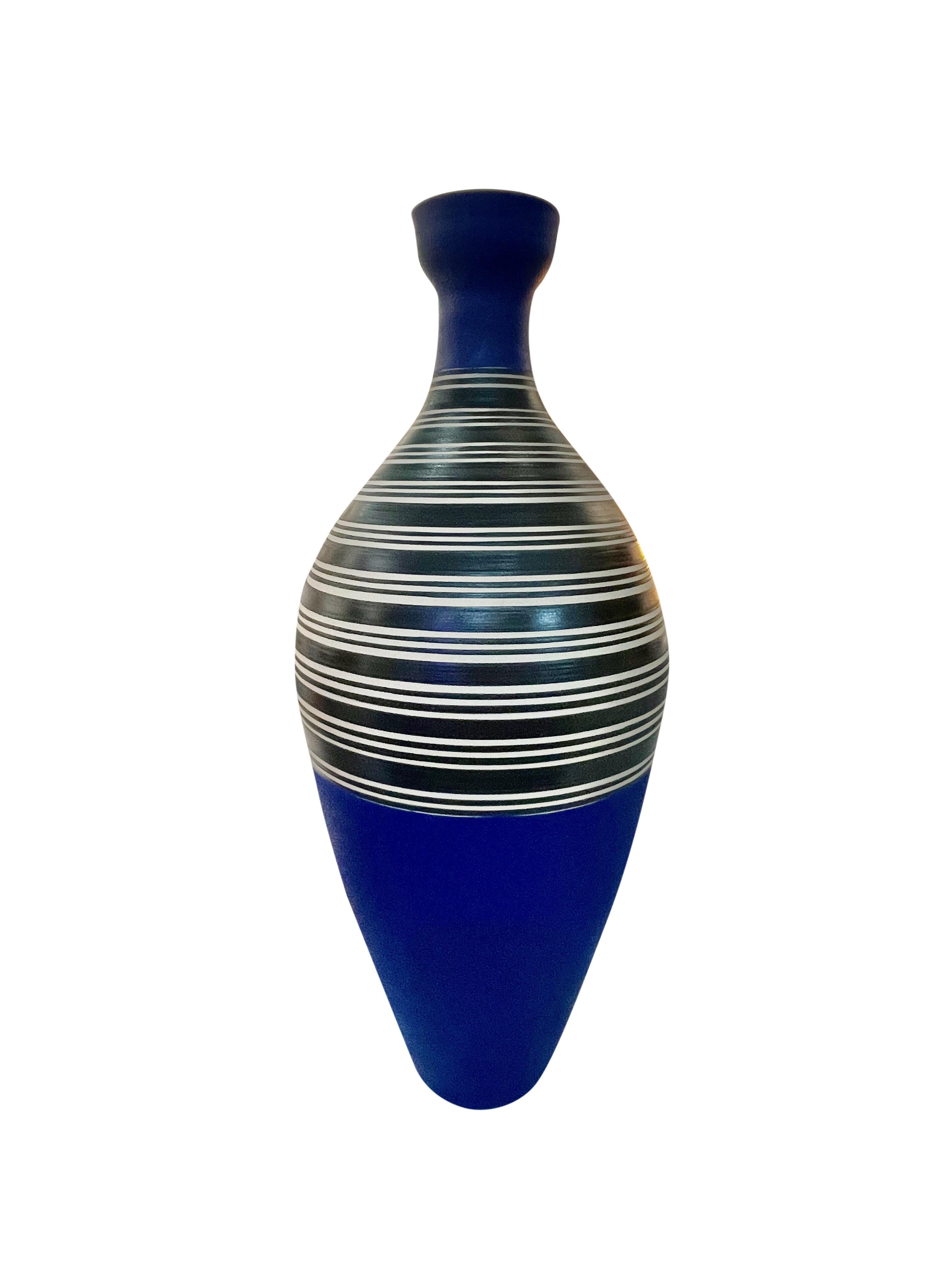 Contemporary Turkish hour glass shaped vase with cobalt blue base and cup top opening.
Bands of black and white stripes in the center of the vase.
