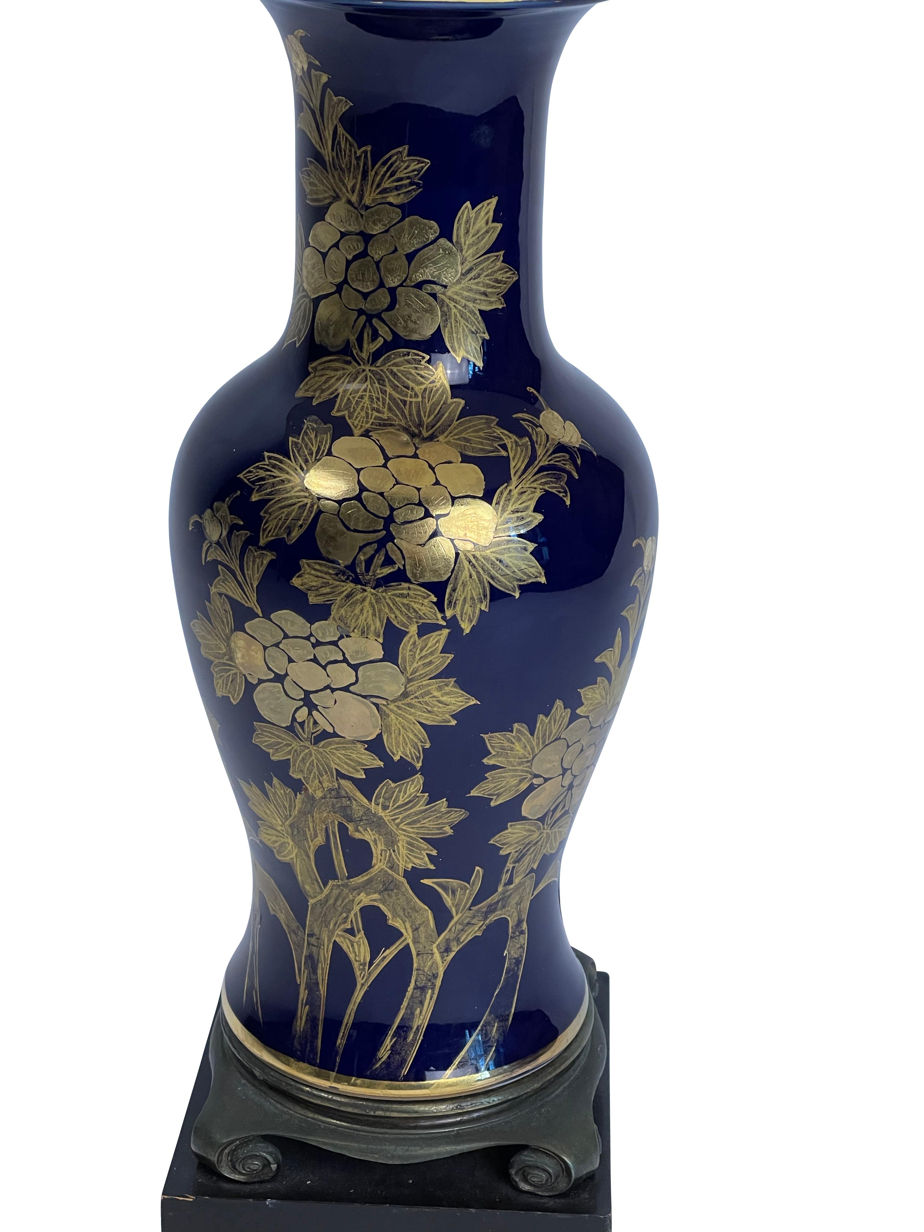 Cobalt blue and gold Japanese design porcelain lamp. New beige curve bell lamp shade.
Measures: 31 inches high by 6.5 inches wide. 

 