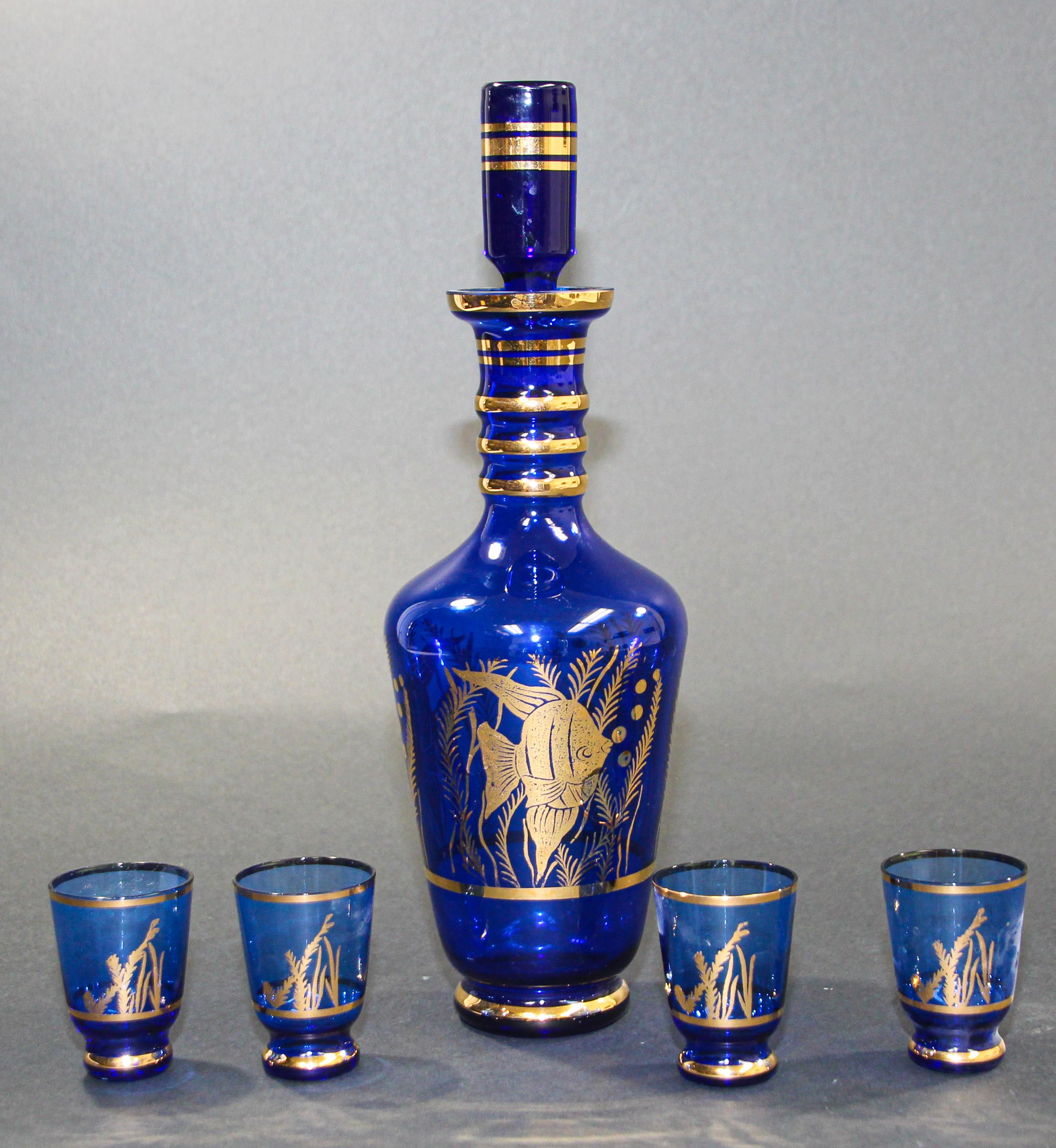 Cobalt blue enameled glass liquor set or aperitif service of five pieces, comprised of a decanter and four shot glasses.
Mouth blown glass in a stunning electric cobalt blue color enhanced with hand-painted enamel.
Measures: 12