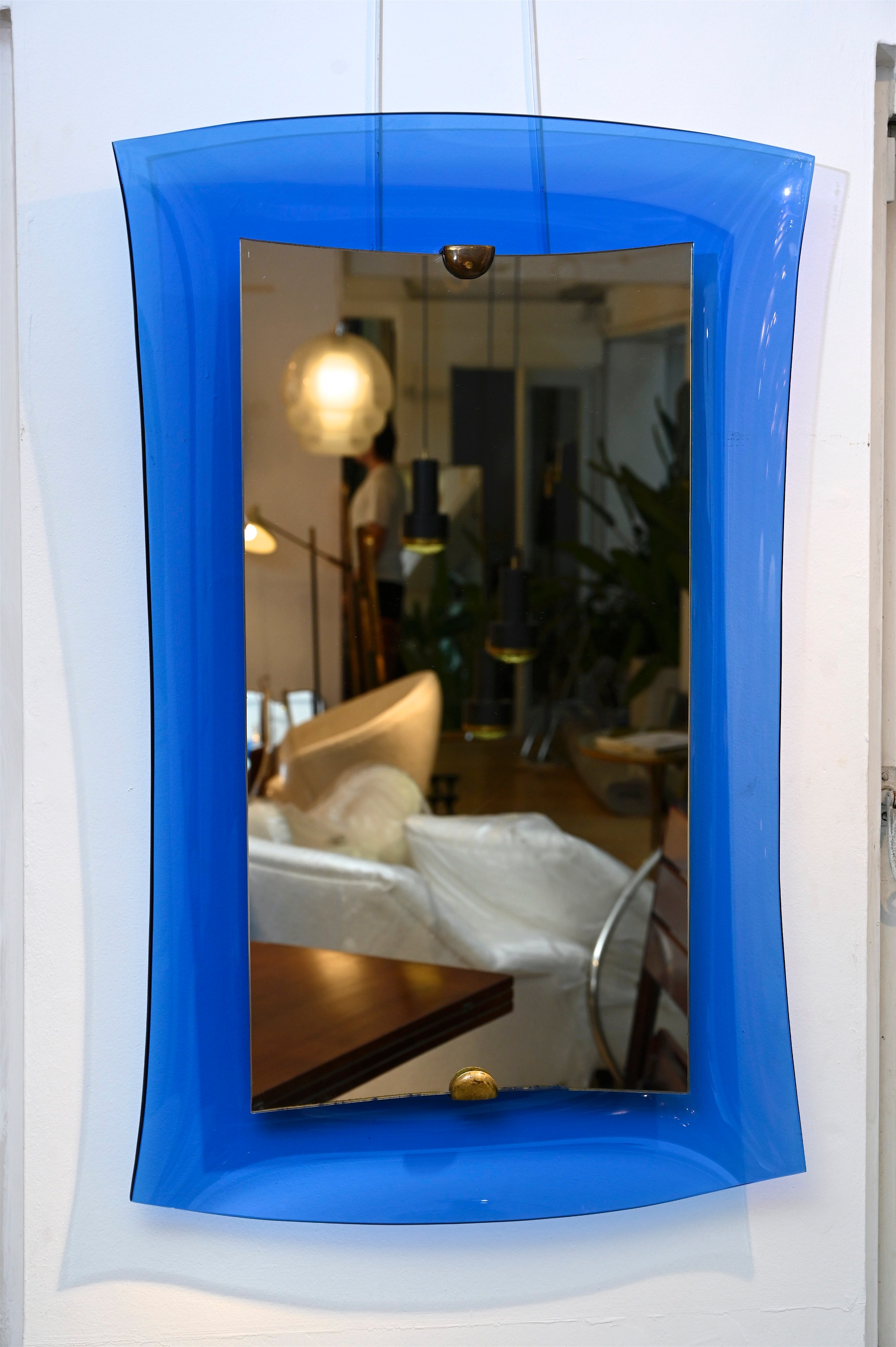 Lovely quality mirror suspended over a curved blue glass 'frame', circa 1950, Italy.

 