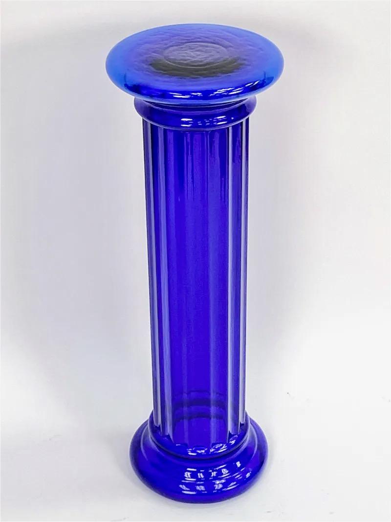Wonderful Pedestal Stand in the form of a classical fluted Doric column made of mouth-blown translucent cobalt blue glass from the Masterwork Collection by Pilgrim Art Glass of West Virginia circa 1980. 36 inches high by 11.5 inches diameter. The