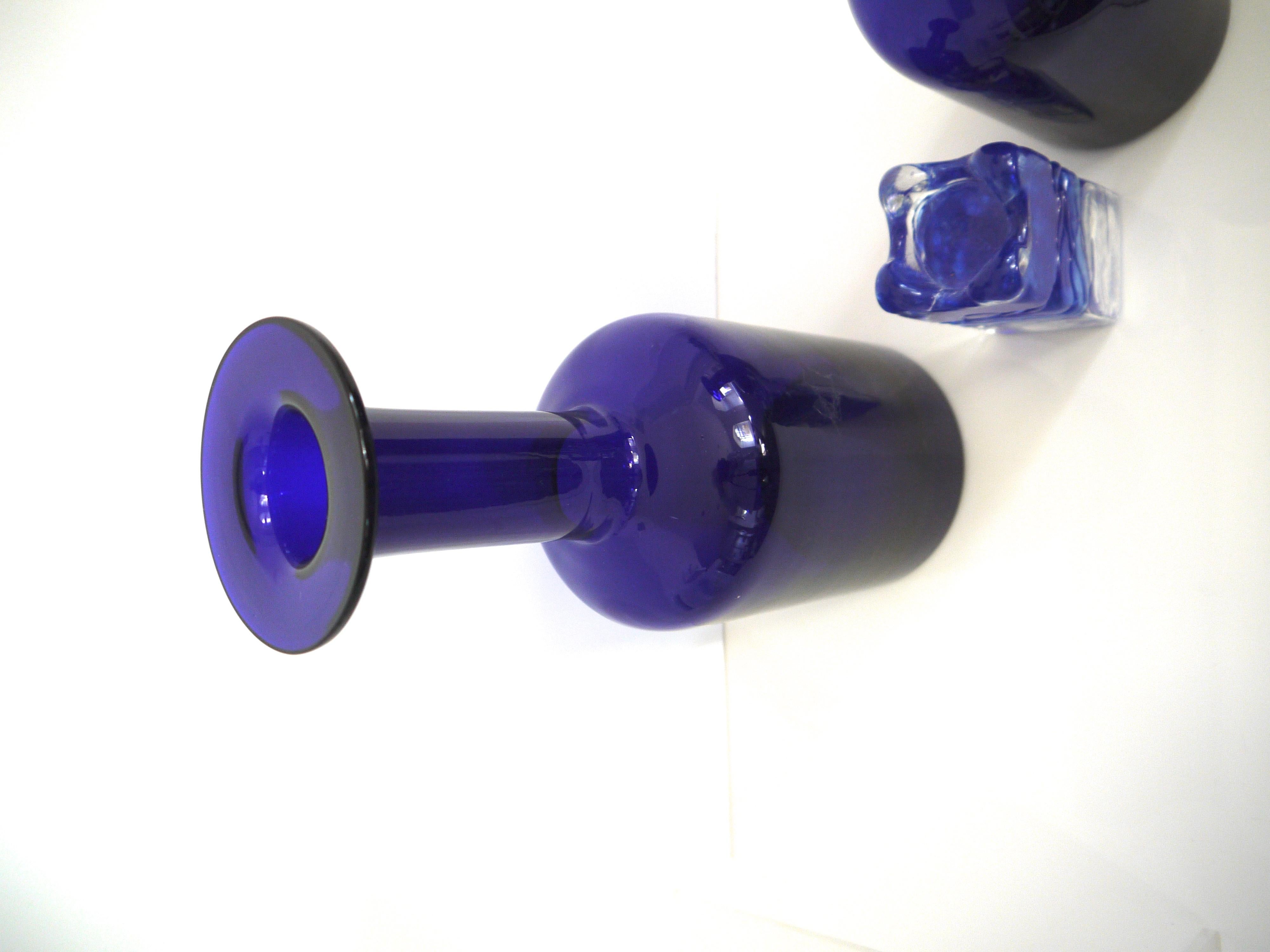 A pair of cobalt blue Gulvases by Otto Brauer based on a design by Per Lutken in 1958 for Holmegaard Kastrup
Styled with a candleholder by Ingrid Glasshutte.
The larger vase is 30 cms in height the small 25 cms.
