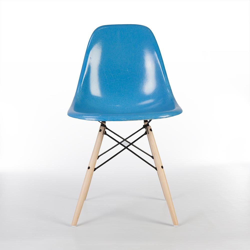 A beautiful, original, cobalt blue Herman Miller Eames side shell on a striking Maple used, newer, DSW dowel base creates a perfect Classic dining chair. The shell is in a generally good vintage condition though does feature an aged mark on the seat