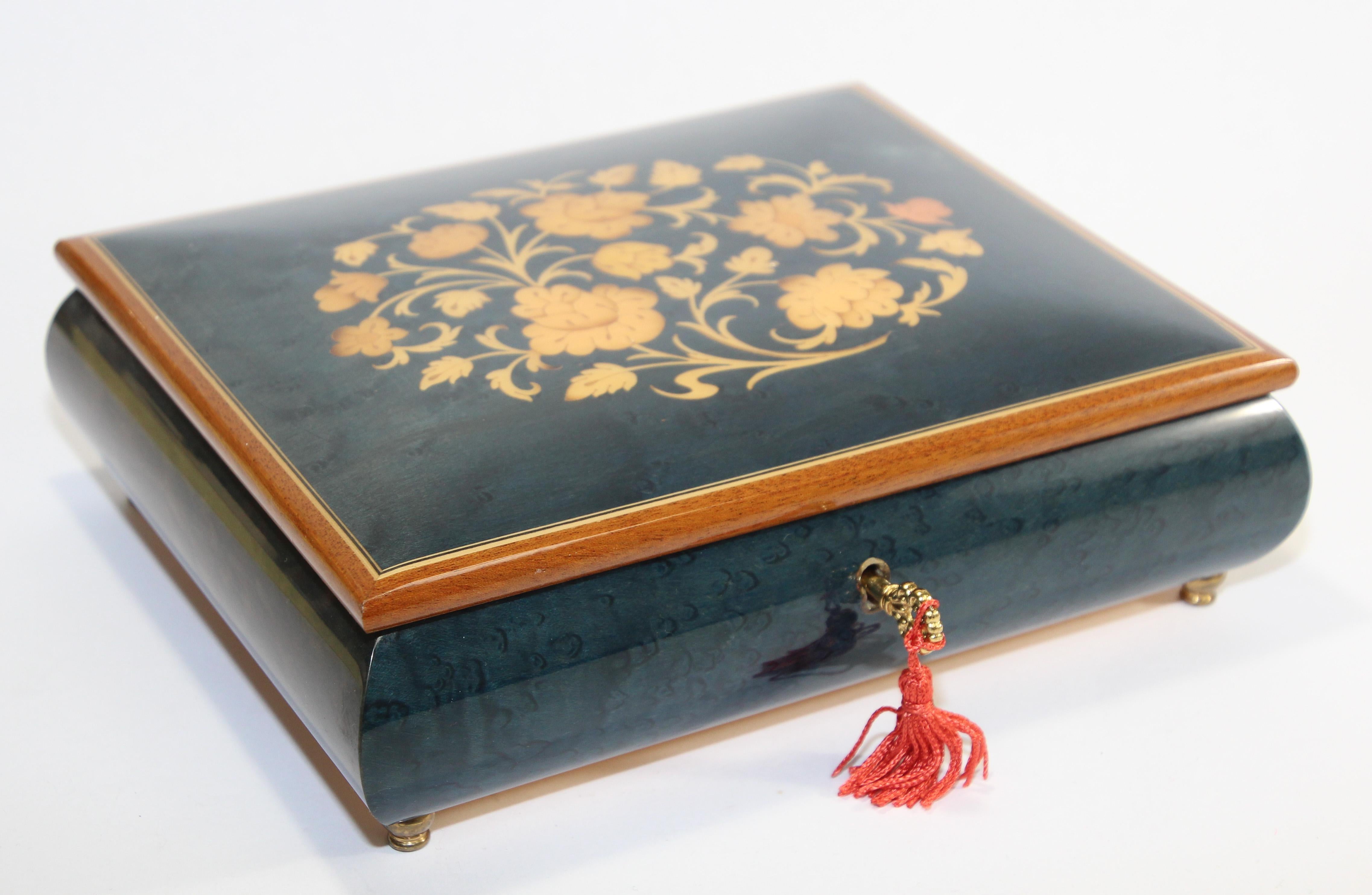 Elegant large handcrafted footed wooden music box in thuya wood hand painted.
Thuya tree is famous for rich gold and brown shades of its grain and unique exotic fragrance, similar to cedar.
Lined in red velve, original key with tassel.
Hand painted
