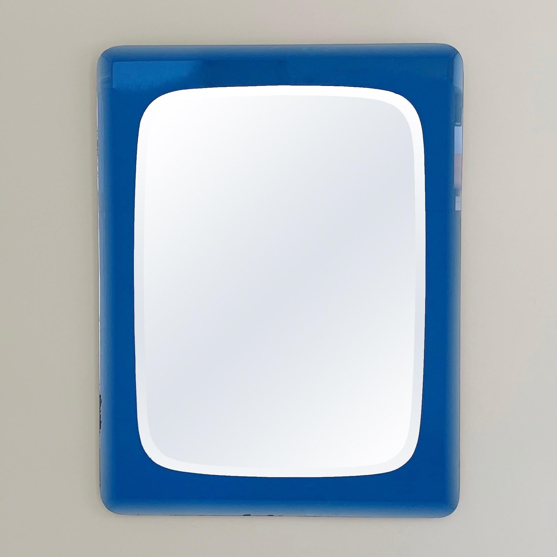 Beautiful midcentury wall mirror by Cristal Arte, circa 1960, Italy.
Double-level: cobalt blue mirrored and beveled glass frame, beveled mirror.
Dimensions: 70 cm W, 90 cm H, 3 cm D.
Rare model on the market, with a nice original vintage