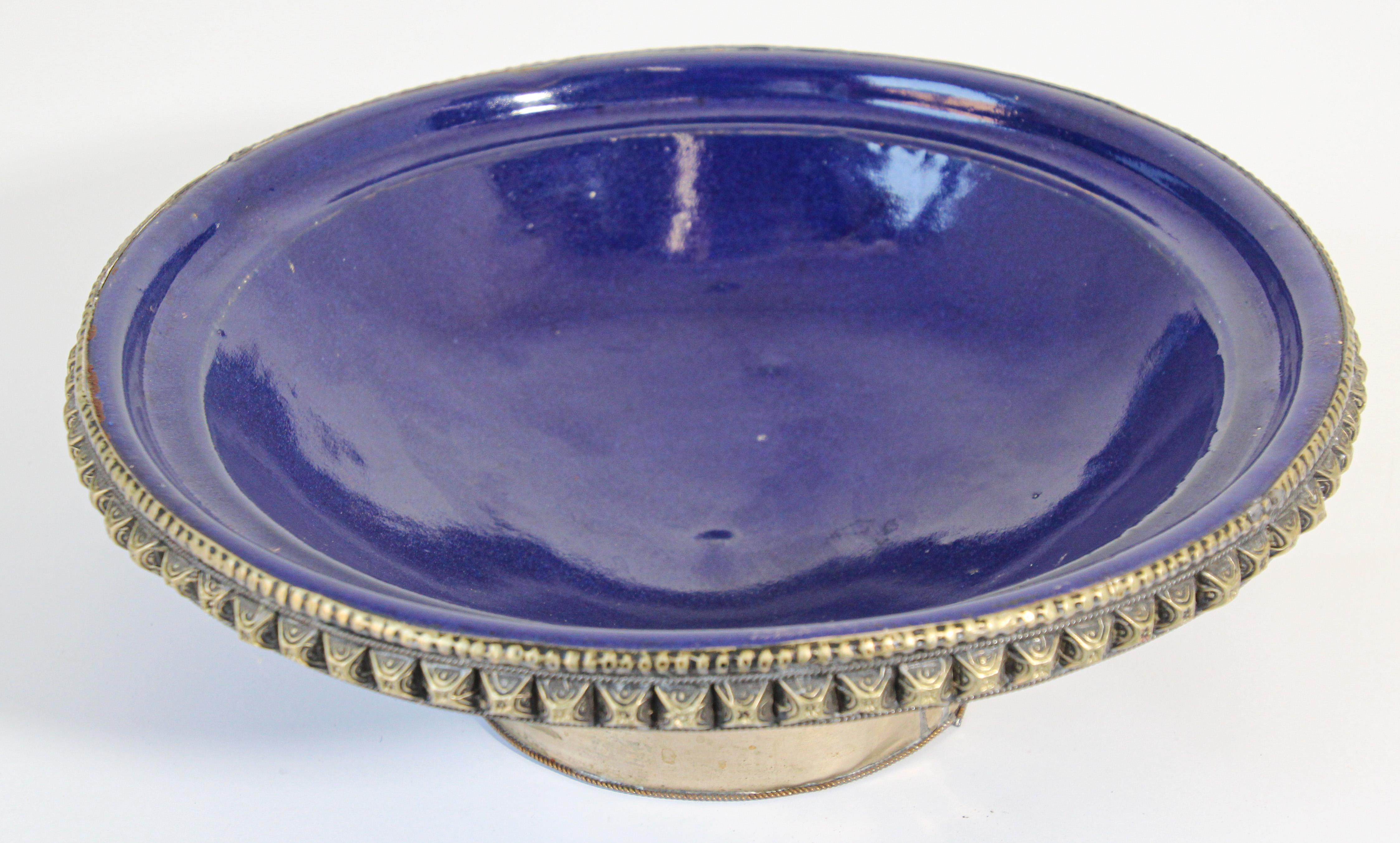 Beautiful cobalt blue Moroccan footed ceramic bowl with silvered metal overlay. 
Great large decorative ceramic bowl. 
Measures: Diameter 11 inches x 4 inches height.