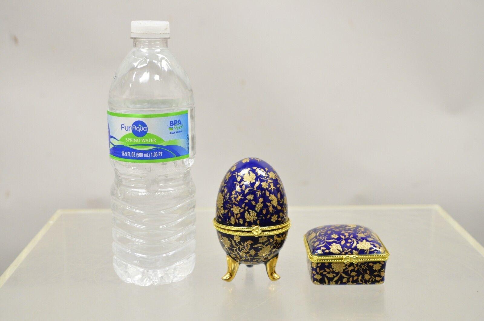Cobalt Blue Porcelain Egg Gold Gilt hinged lid candle trinket box - 2 pcs. Item featurs a porcelain construction, gold gilt details, raised on feet, small hinged box included. Circa Late 20th Century.
Measurements: 
Egg: 3.5