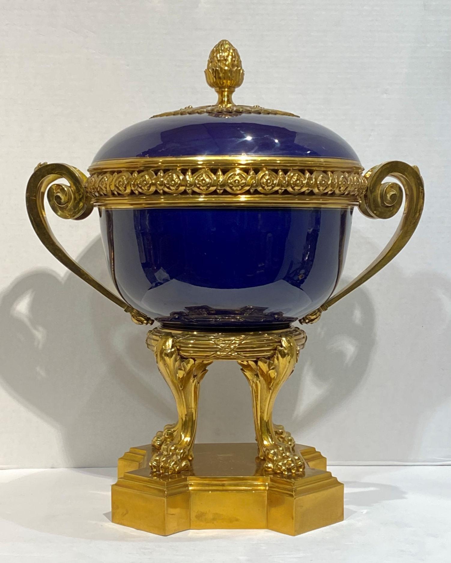 A Sevres style gilt bronze-mounted porcelain cache pot of ovoid form with monochrome cobalt finish, raised on four paw feet.
Measuring width over handles is 17 1/4 inches.