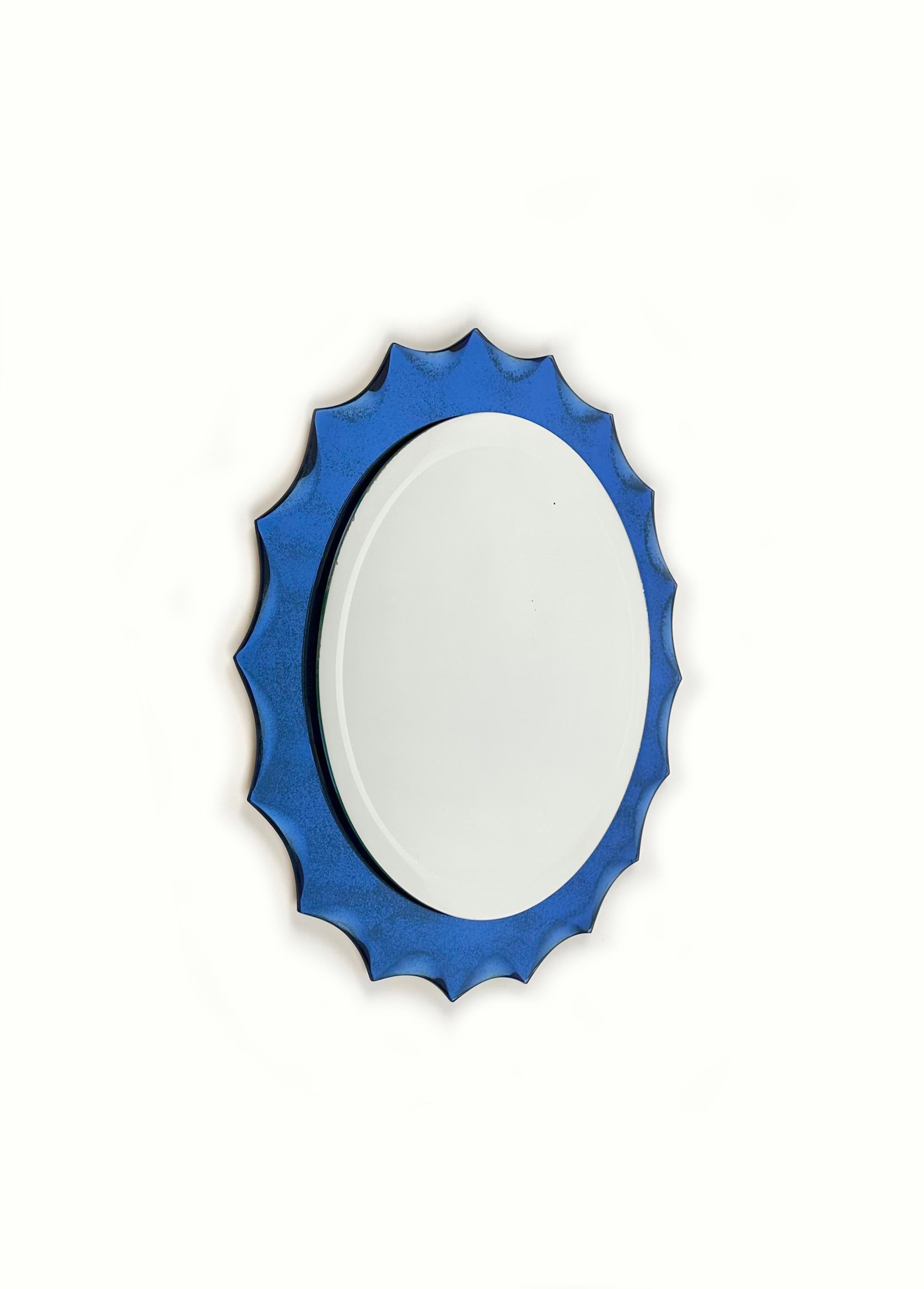 Wall mirror with cobalt blue sunburst frame in Fontana Arte style. 

Made in Italy in the 1960s.

As the pictures show, on the mirror there are signs of time due to the age of the piece (no chips).