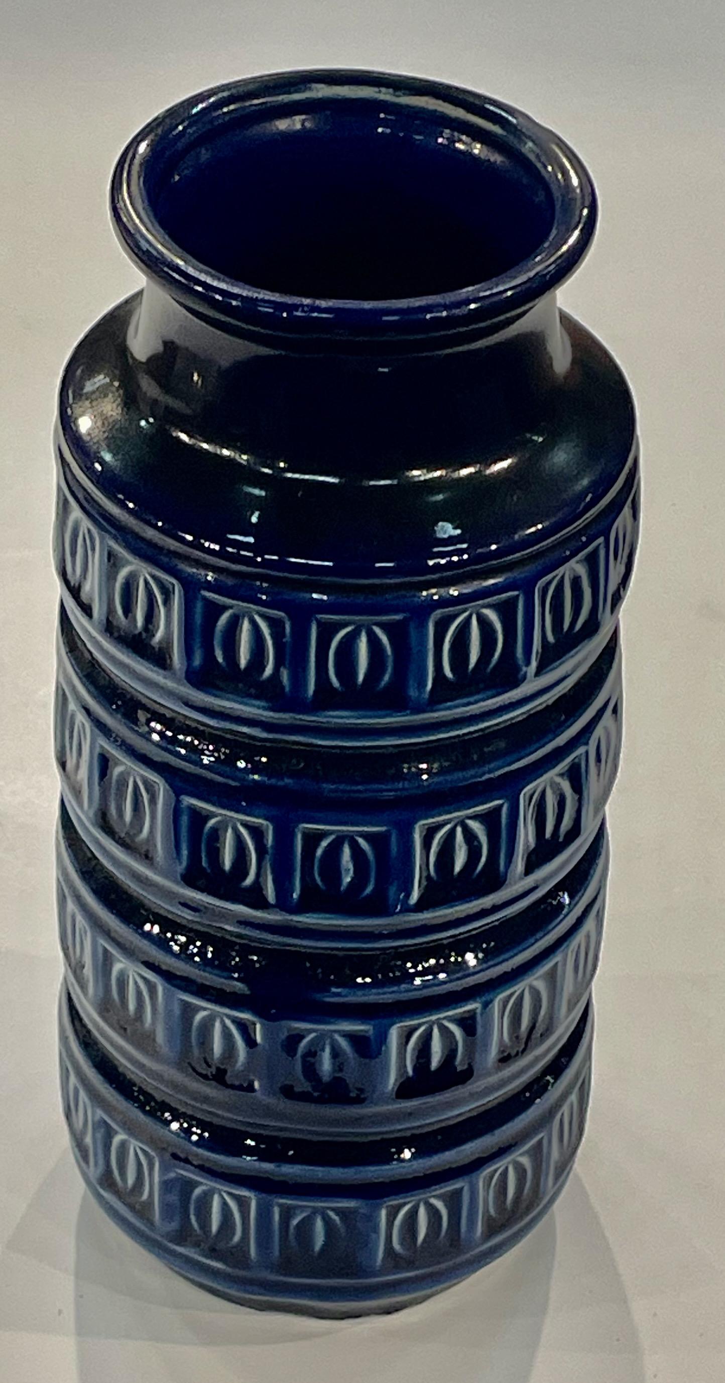 Mid Century German ceramic vase with horizontal bands of raised geometric design.
Cobalt blue in color.
Can hold water.
Sits well with S6757.
